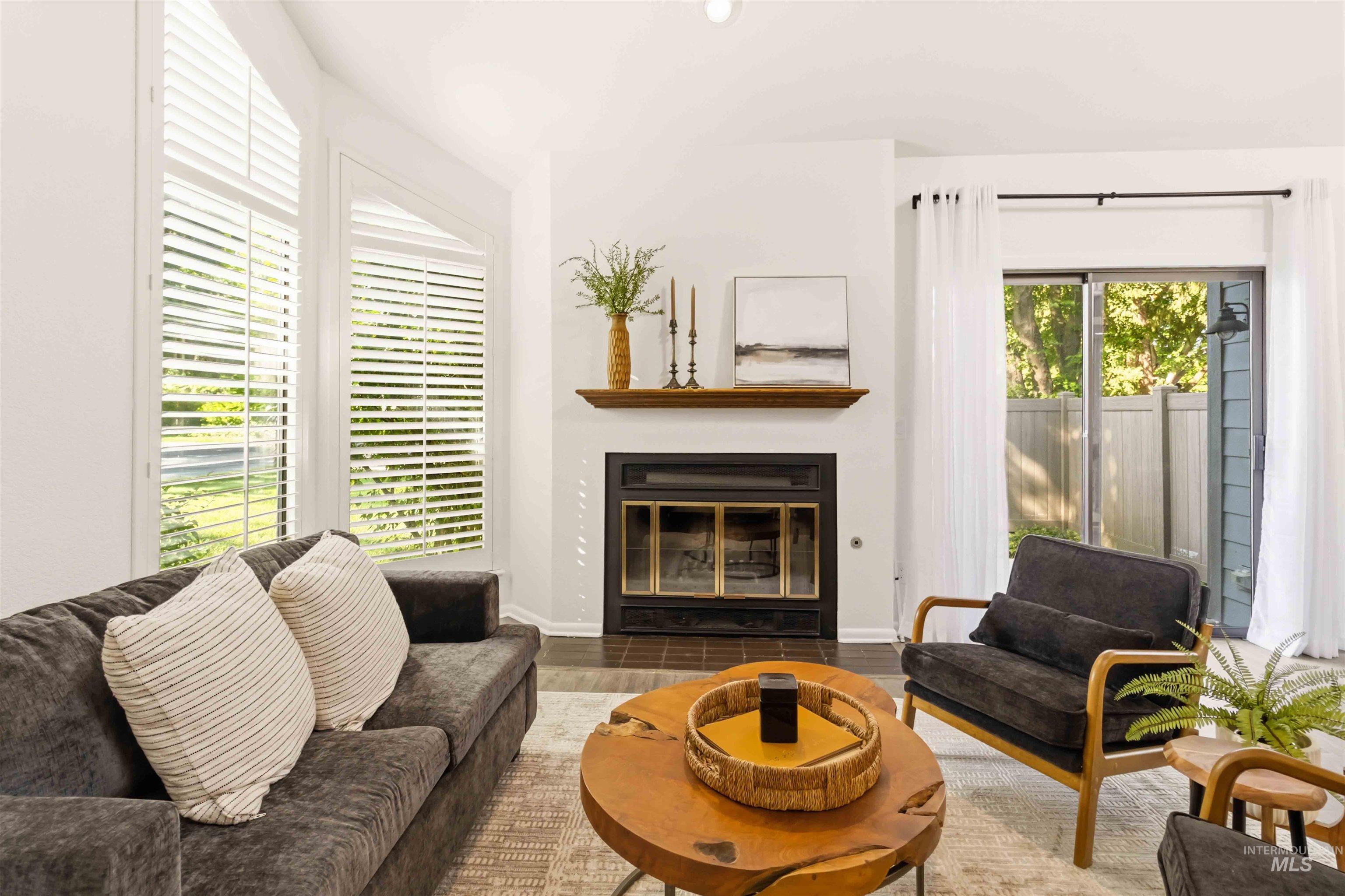 Living area featuring a fireplace with a dark surround and a wood mantel