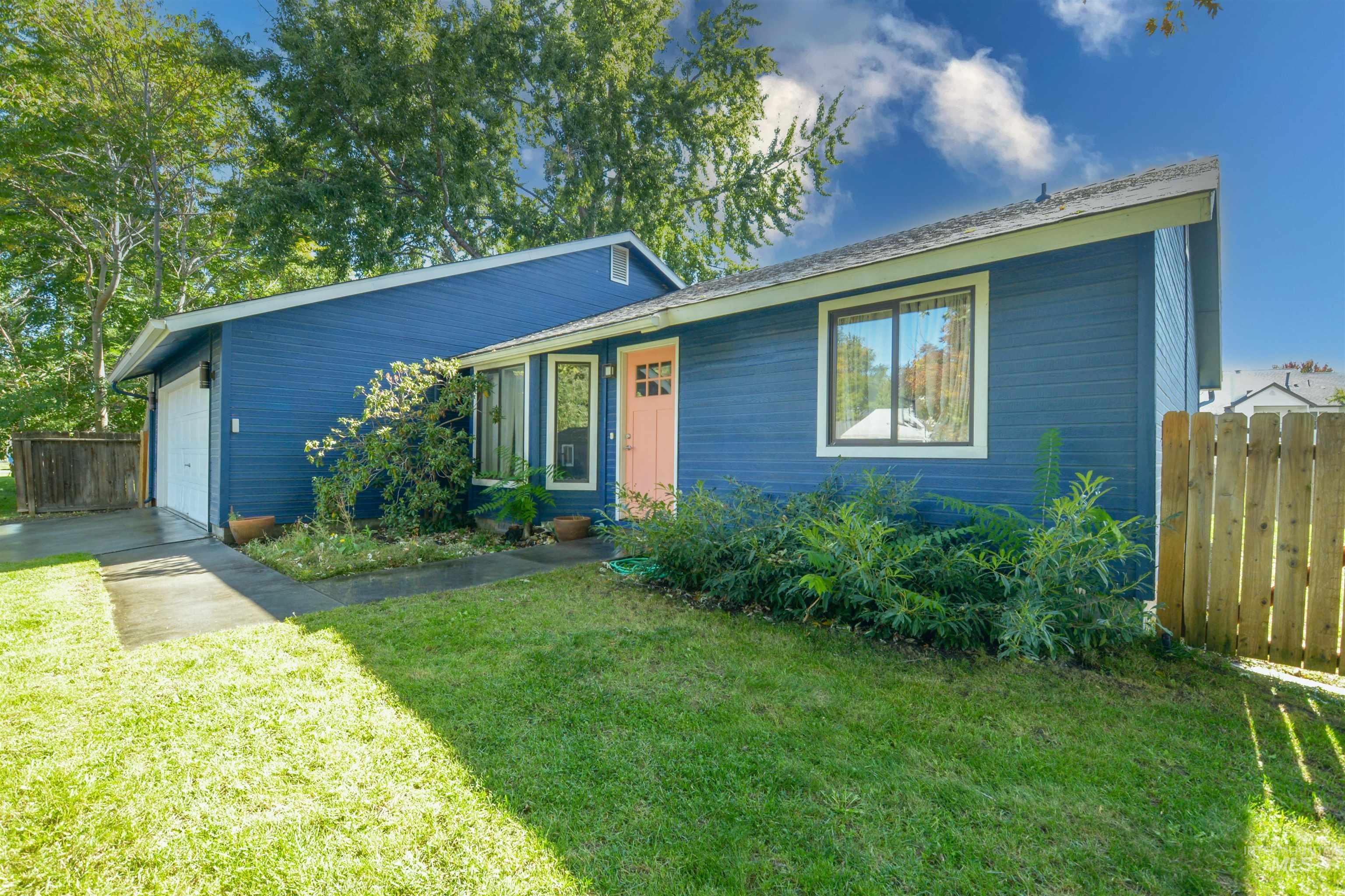 View of front of home with an attached garage and driveway