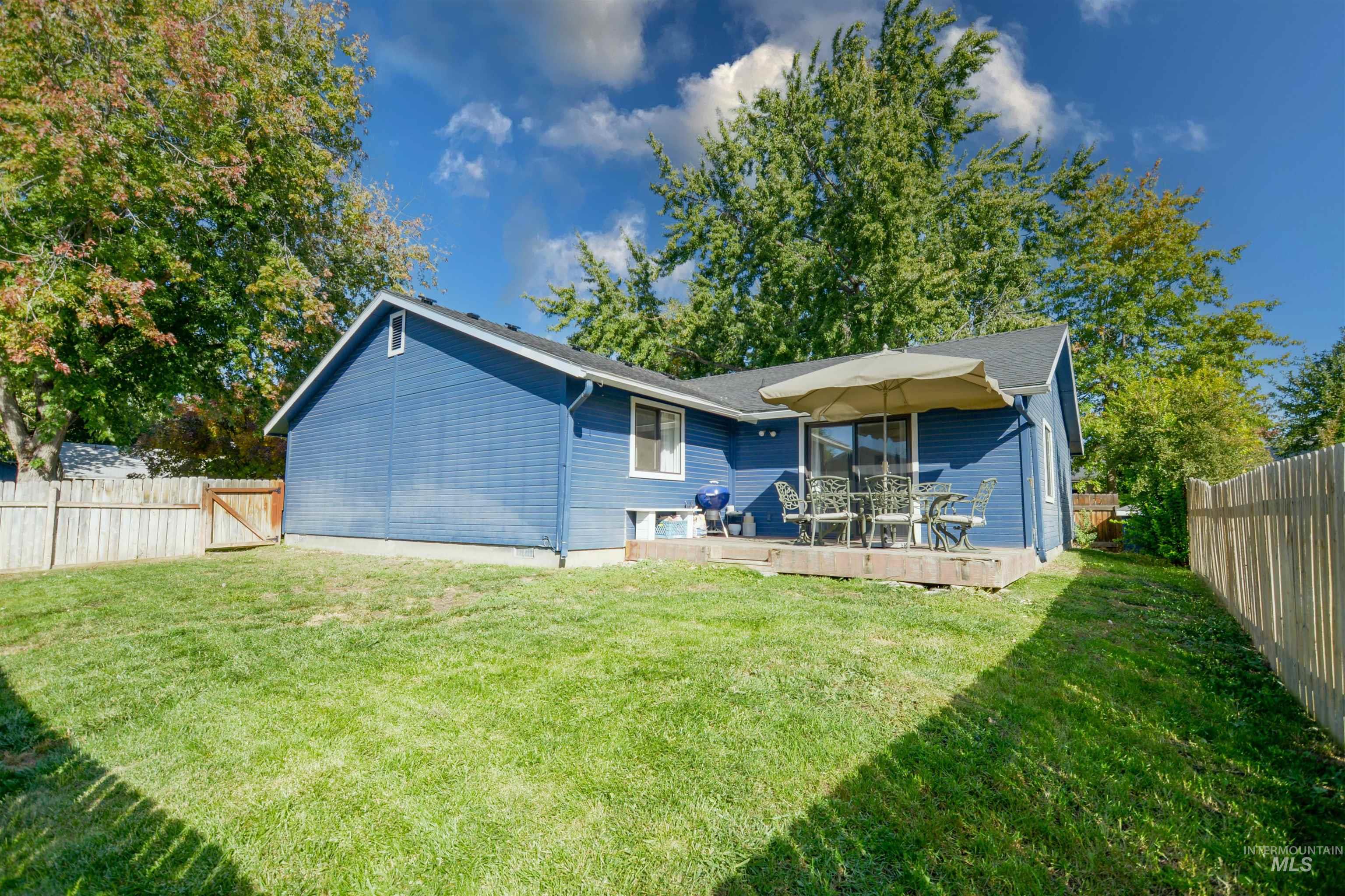 Back of property featuring a fenced backyard and a wooden deck