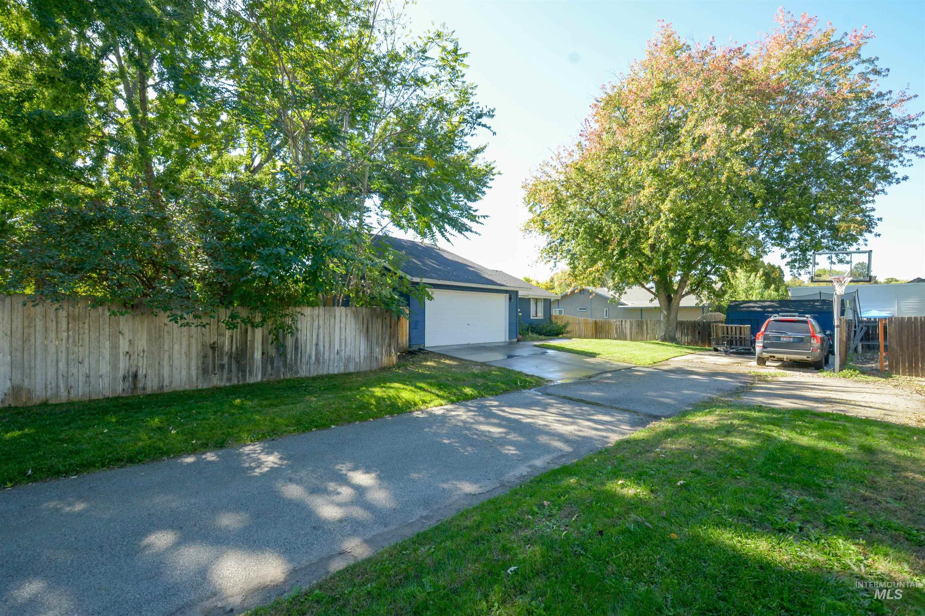 View of front facade featuring concrete driveway and a garage