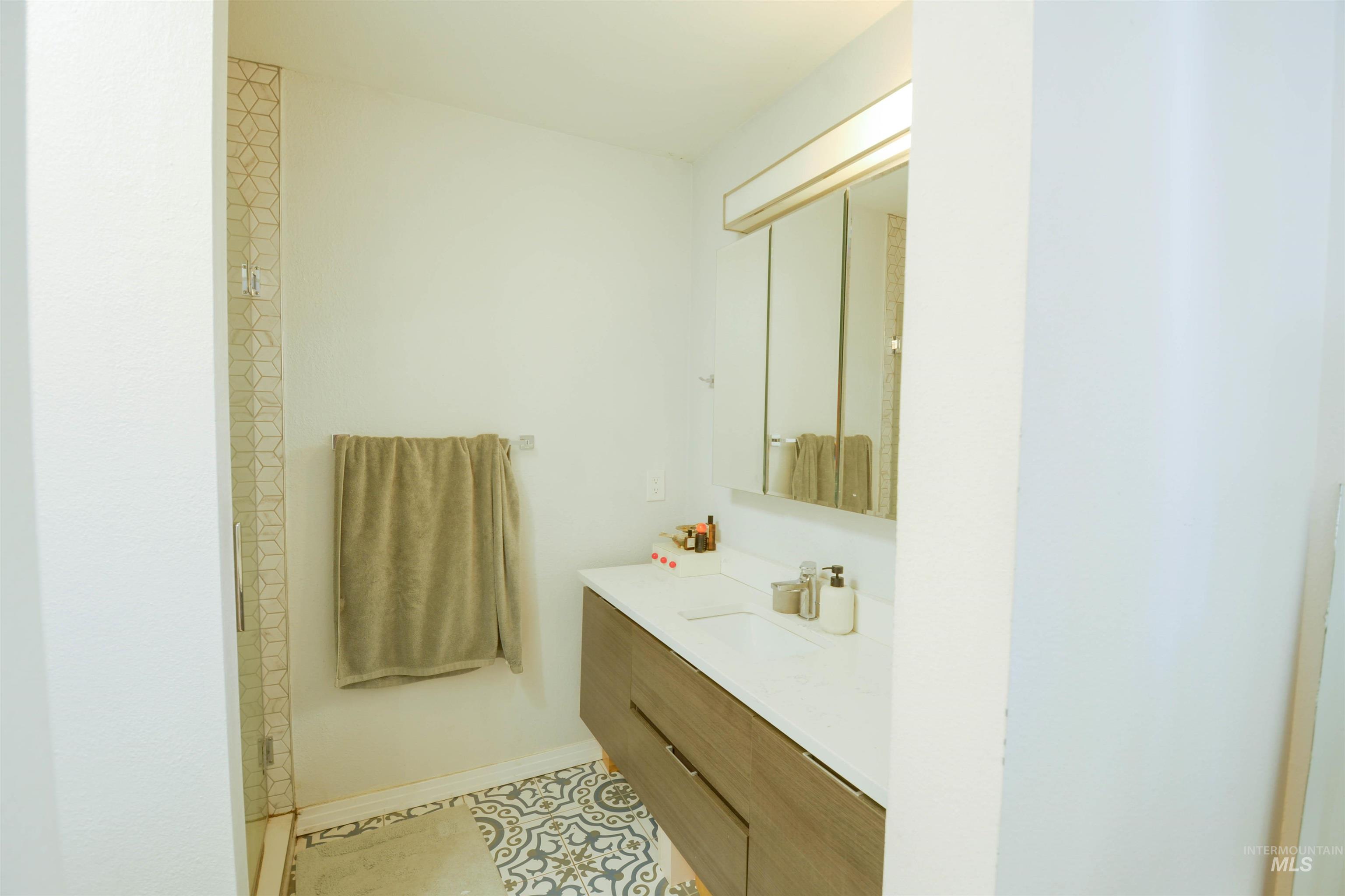 Bathroom featuring vanity and light tile patterned flooring