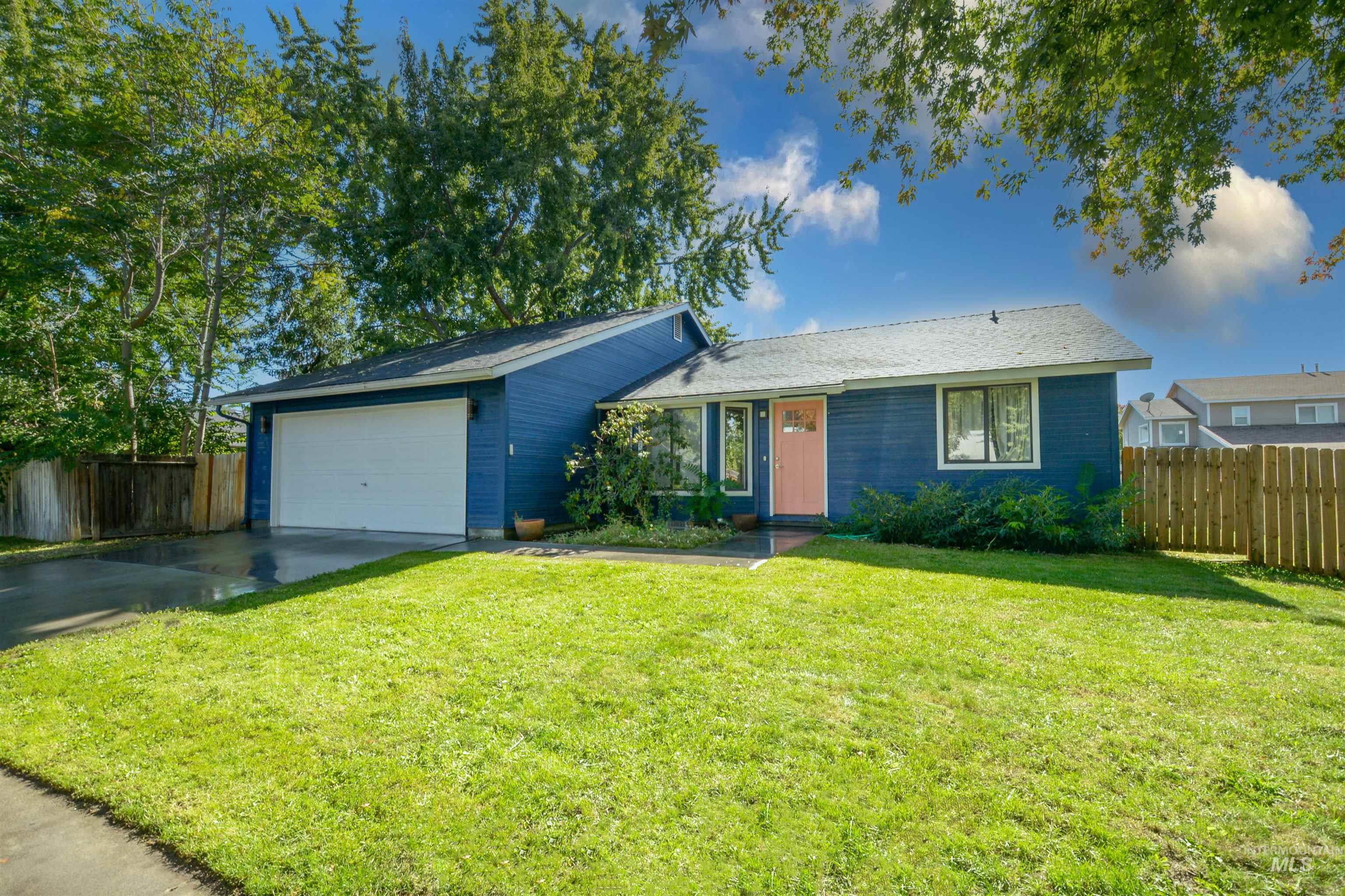 View of front of property featuring concrete driveway and a garage