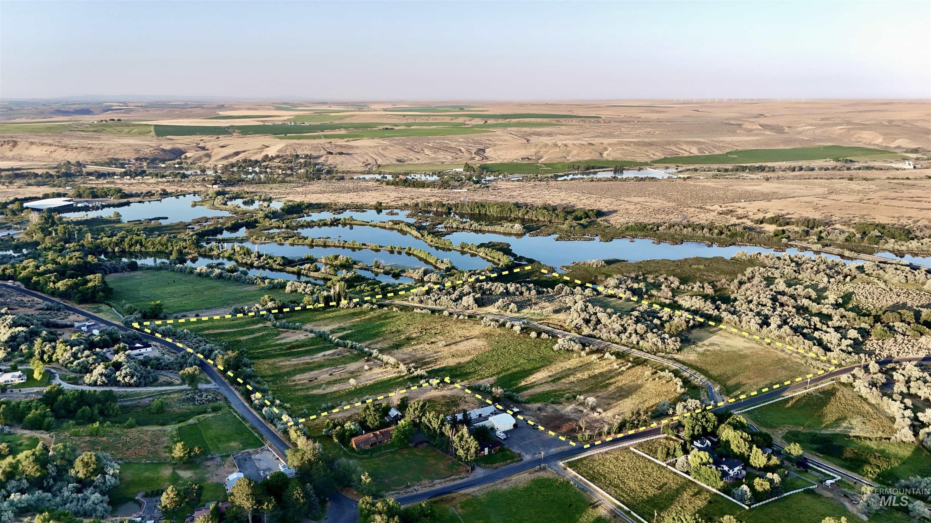 Aerial view of property's location with a nearby body of water and rural landscape