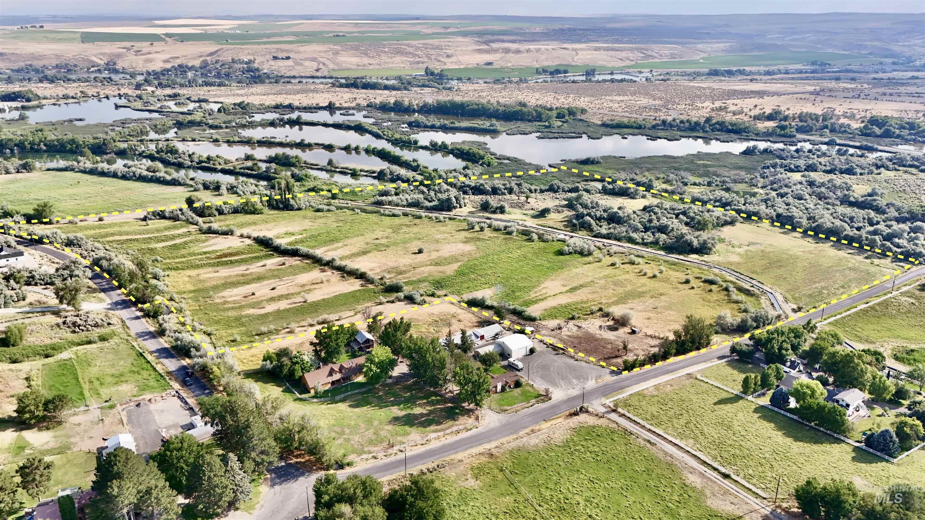 Aerial overview of property's location with rural landscape and a nearby body of water