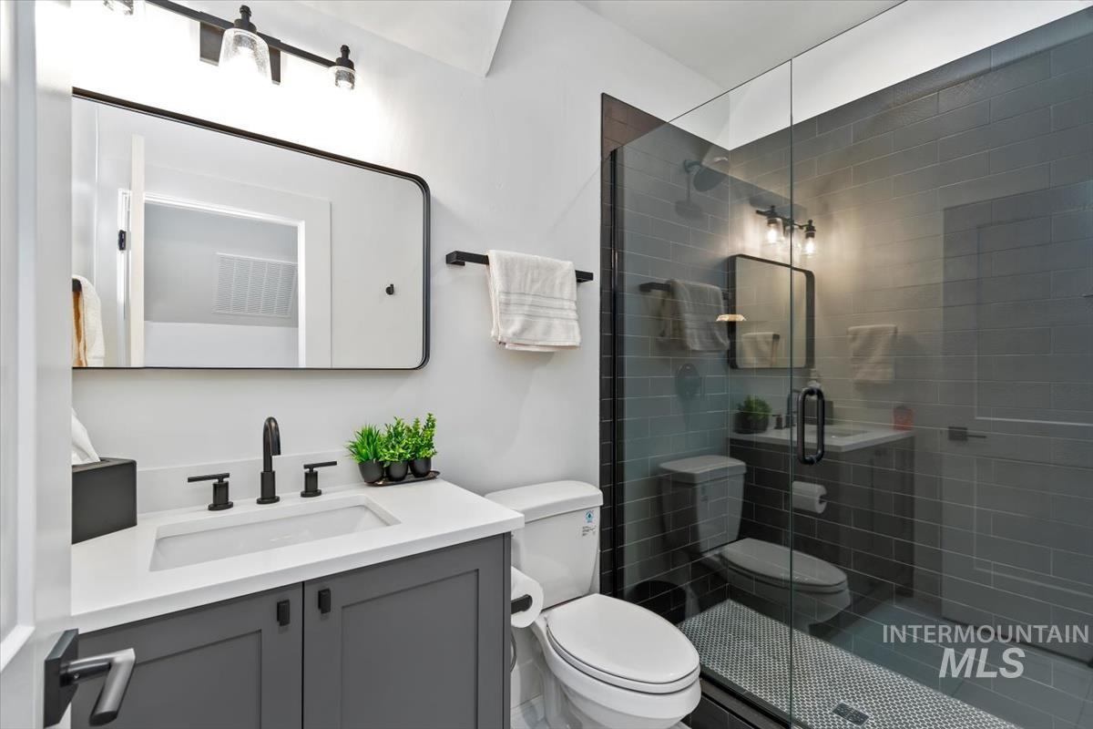 Bathroom with vanity and a shower stall
