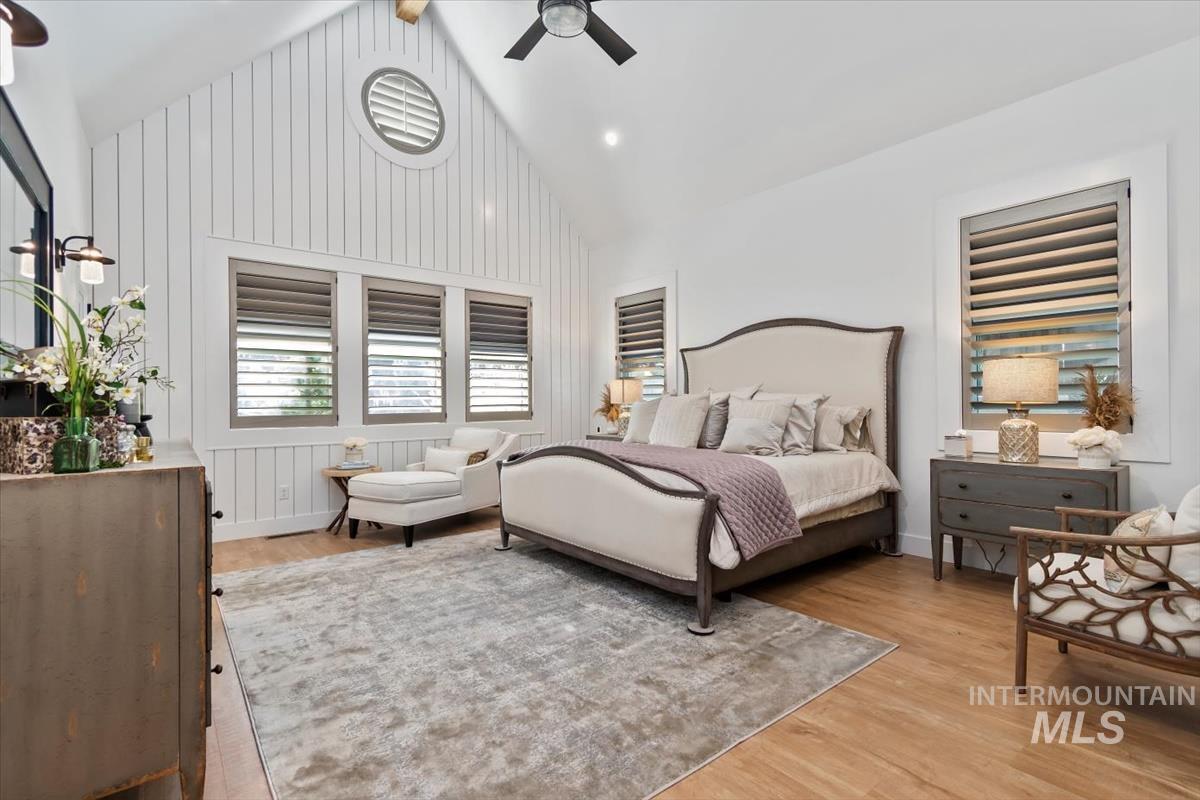 Bedroom featuring light wood finished floors, high vaulted ceiling, ceiling fan, and recessed lighting