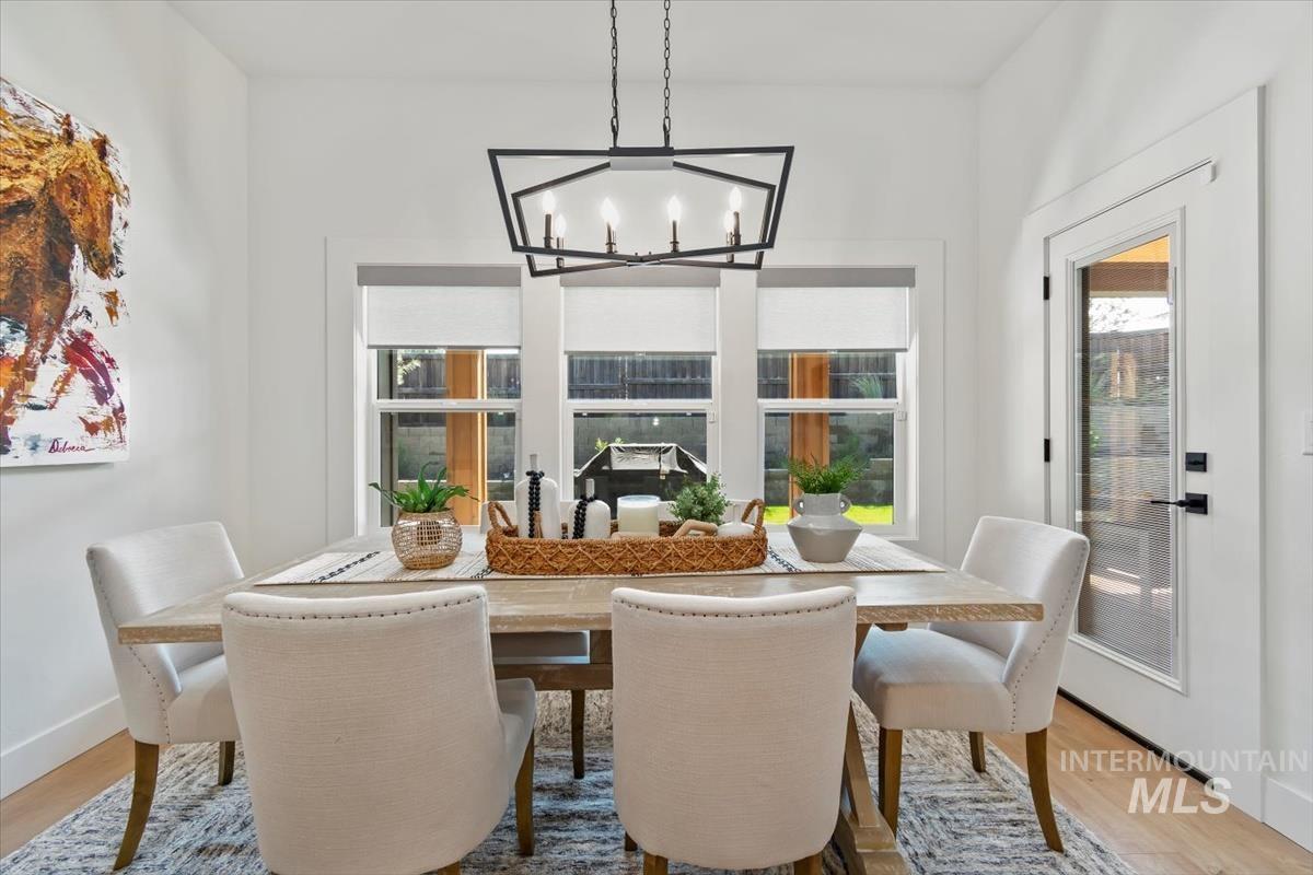 Dining space with light wood-style flooring and a chandelier