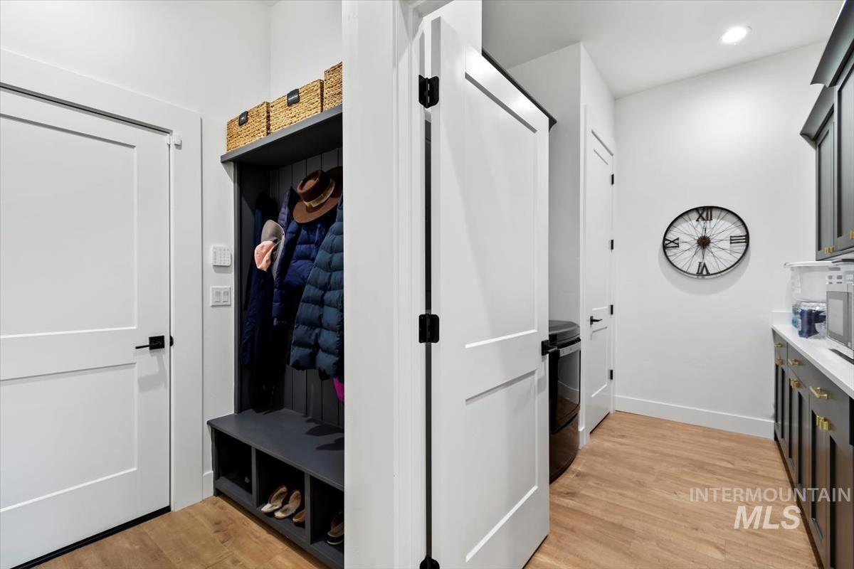 Mudroom featuring light wood-type flooring and washer / clothes dryer