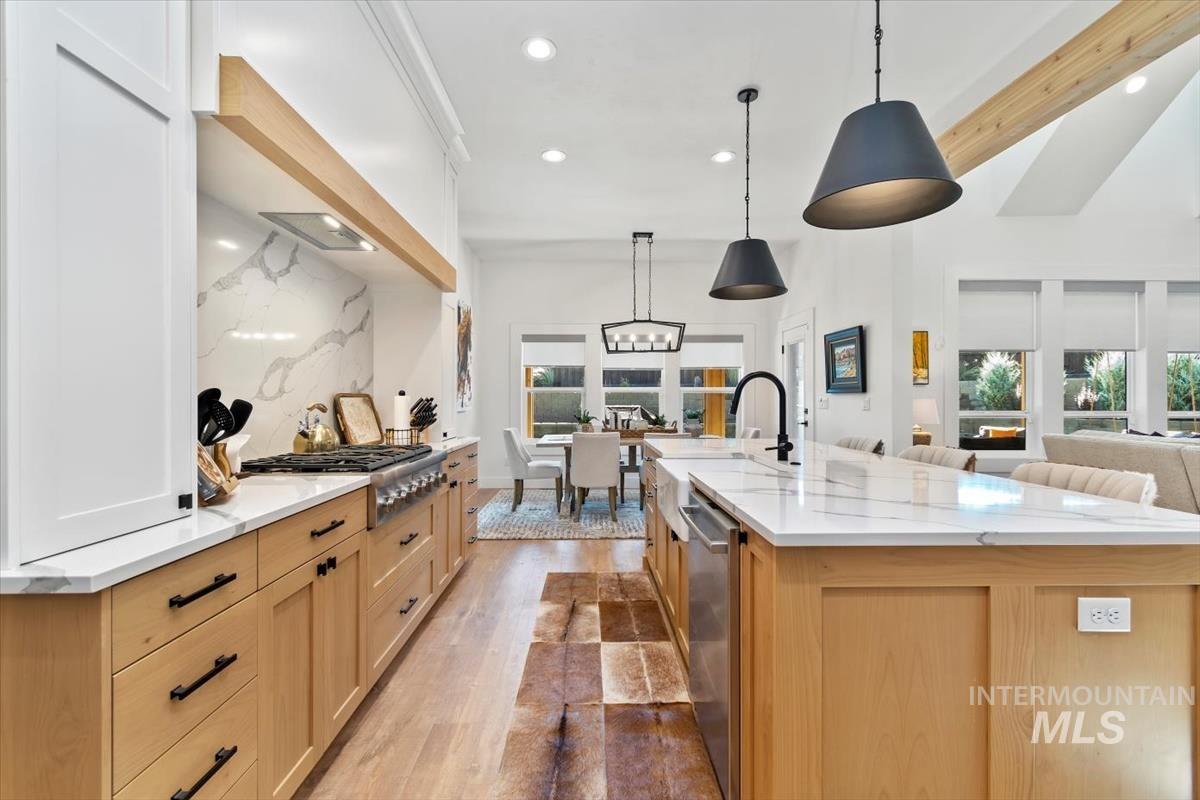 Kitchen featuring light wood-style flooring, light brown cabinets, recessed lighting, healthy amount of natural light, and hanging light fixtures