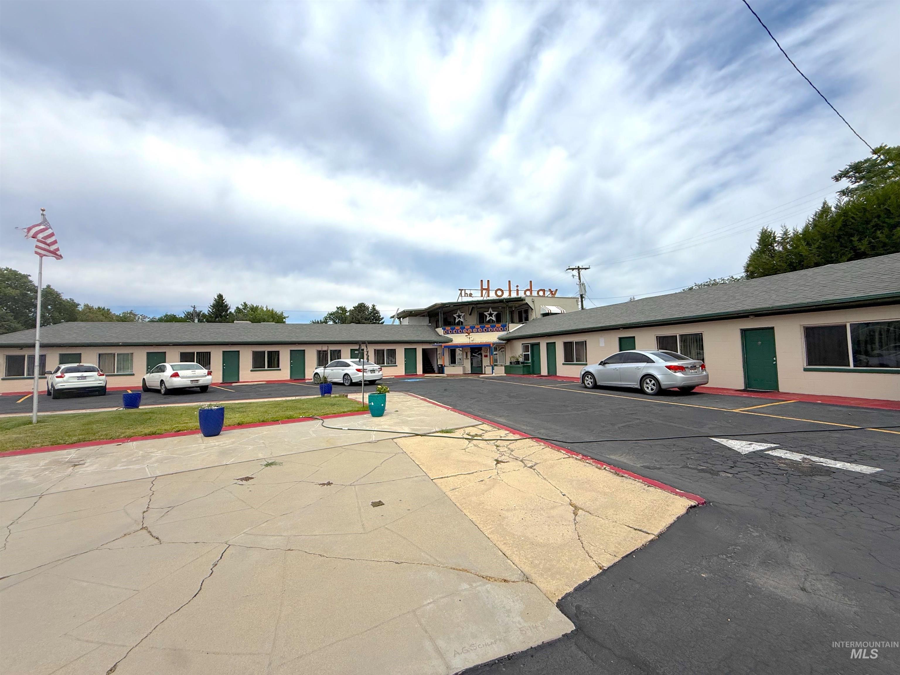 View of property featuring uncovered parking