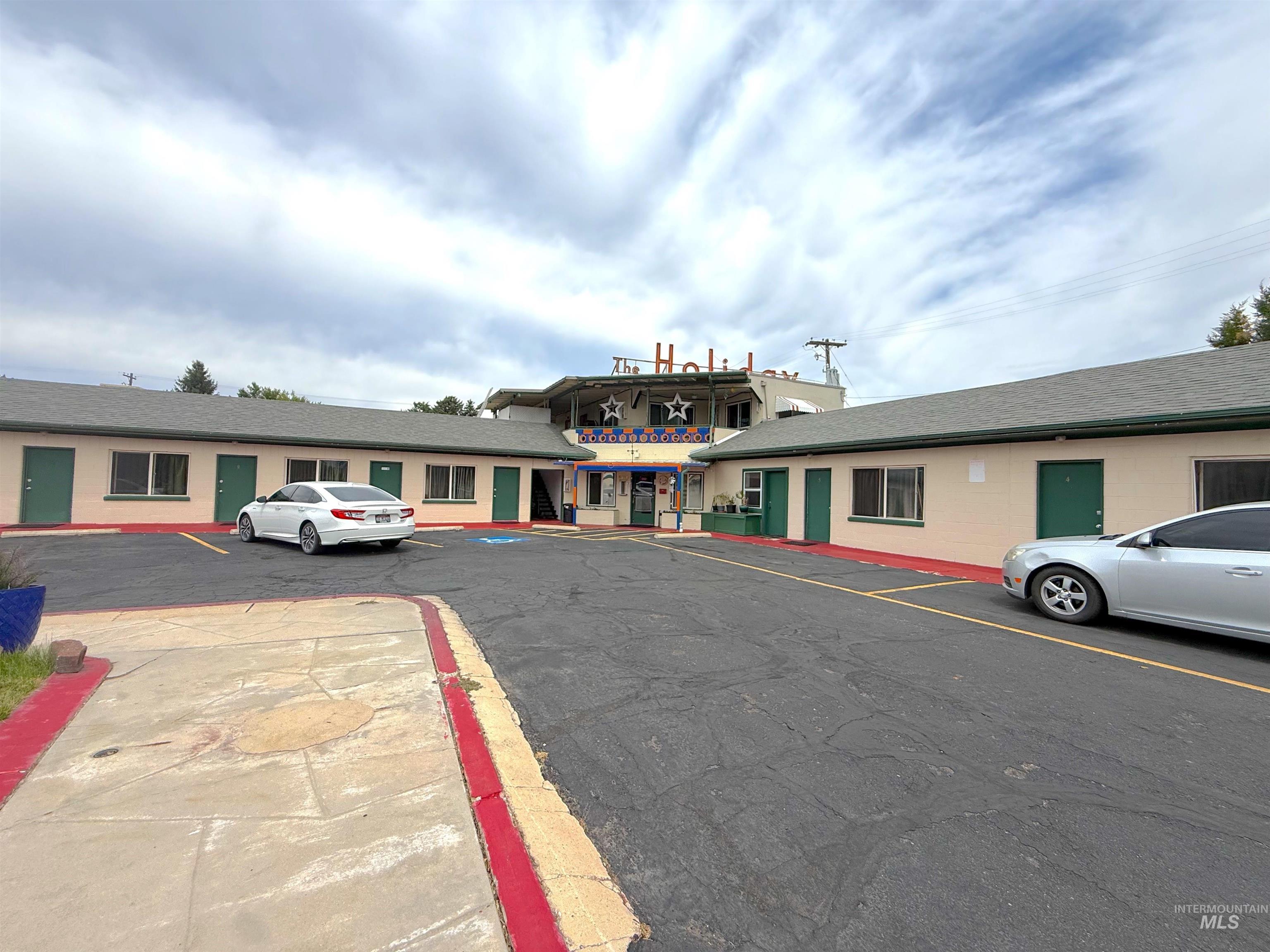 View of property featuring uncovered parking