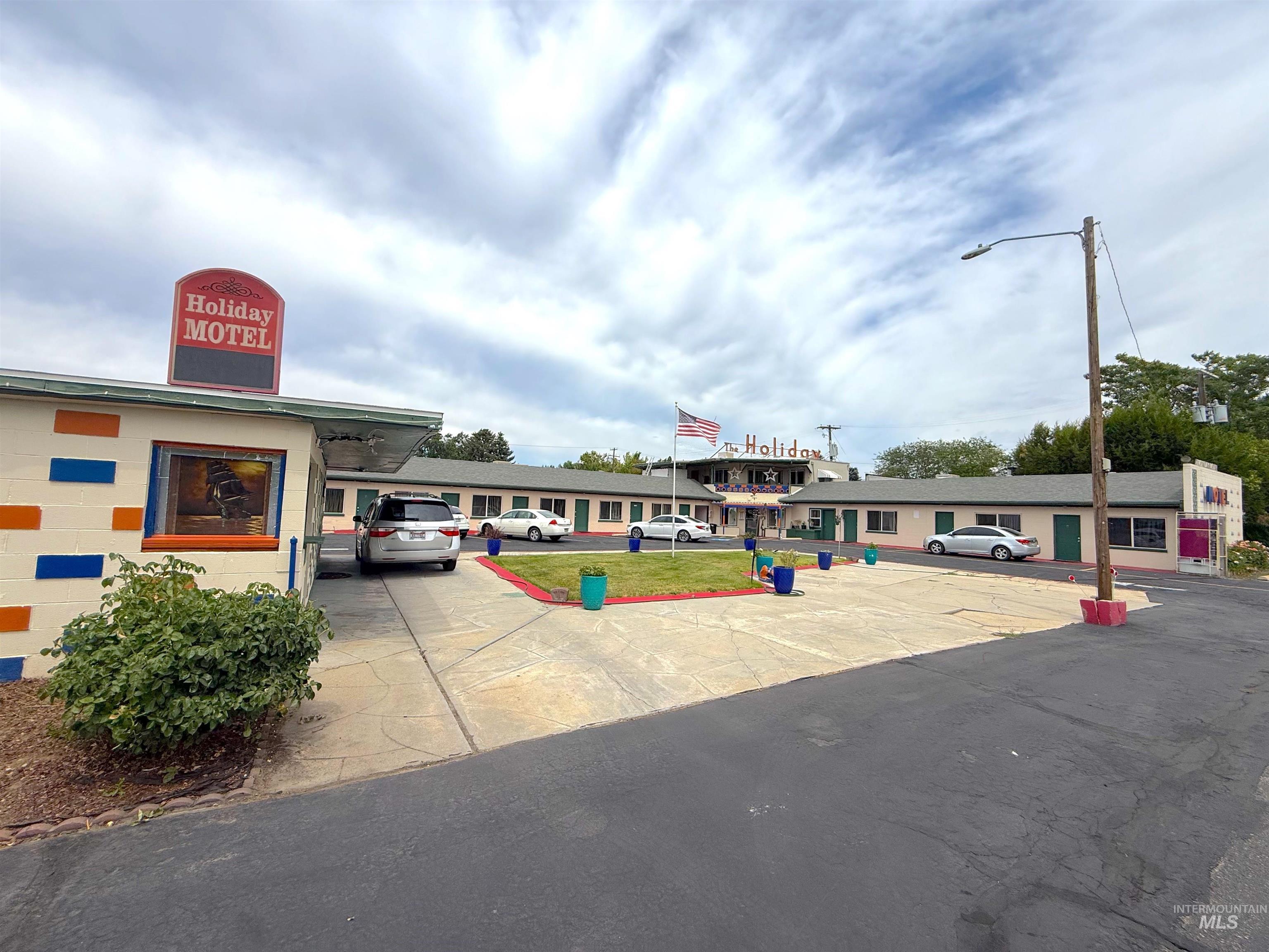 View of property with uncovered parking