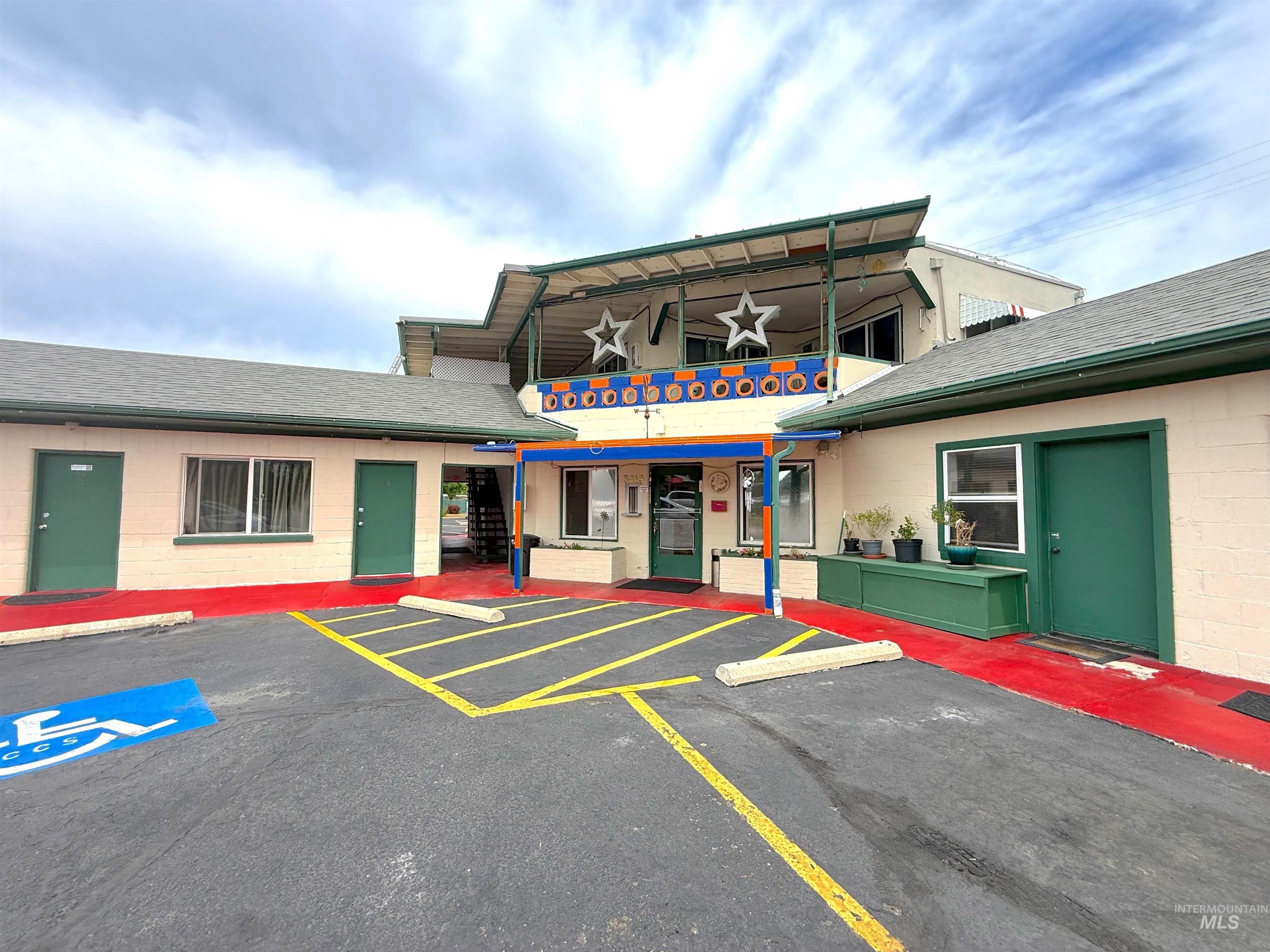 View of property with uncovered parking