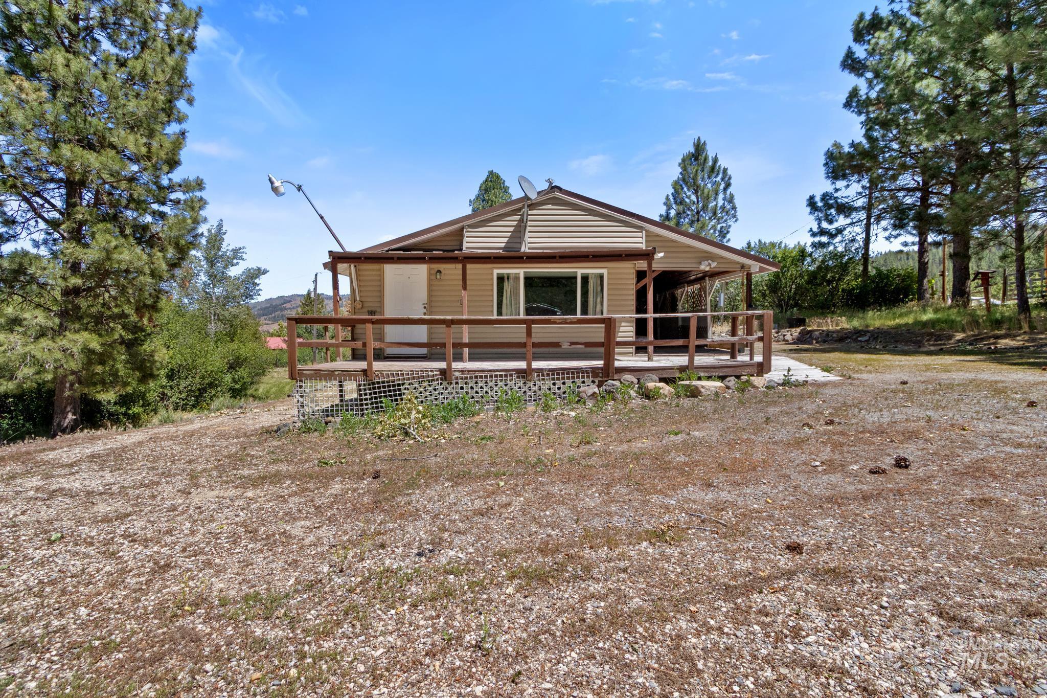 Ranch-style exterior with horizontal siding and a covered wooden deck