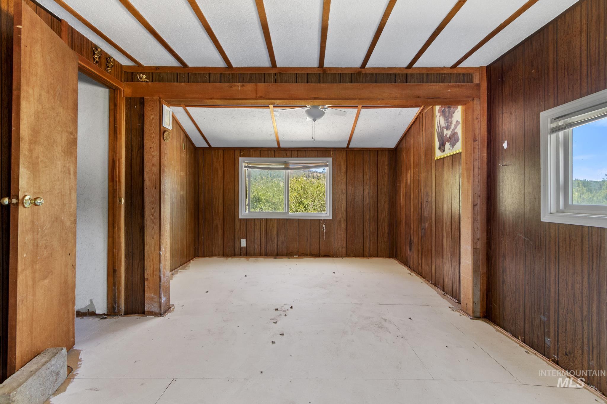 Paneled wood walls and a wood-beamed ceiling