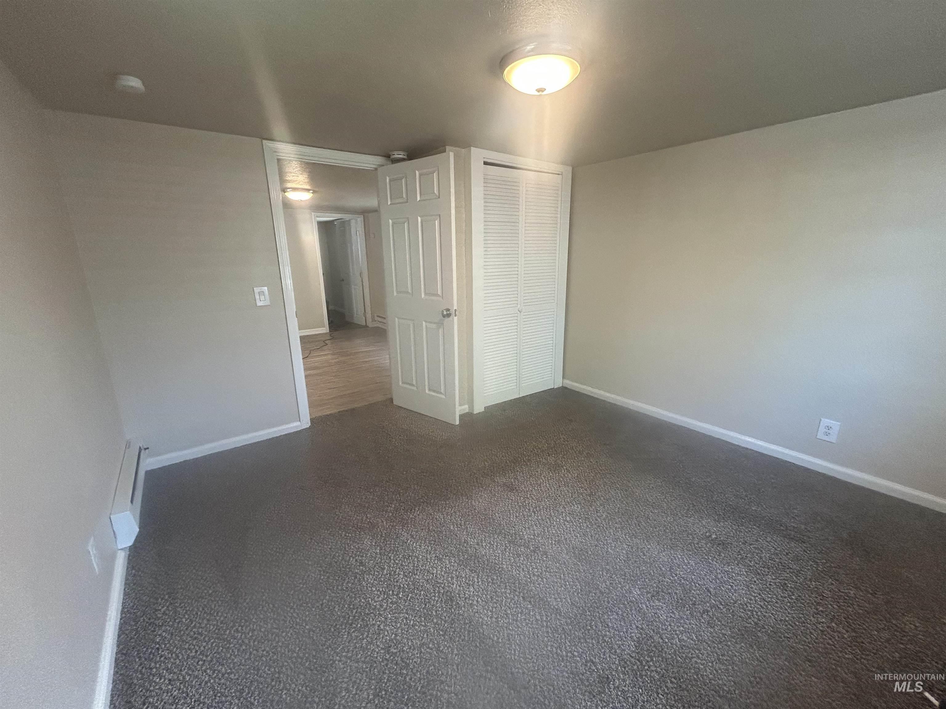 Large master bedroom with natural light and a closet.