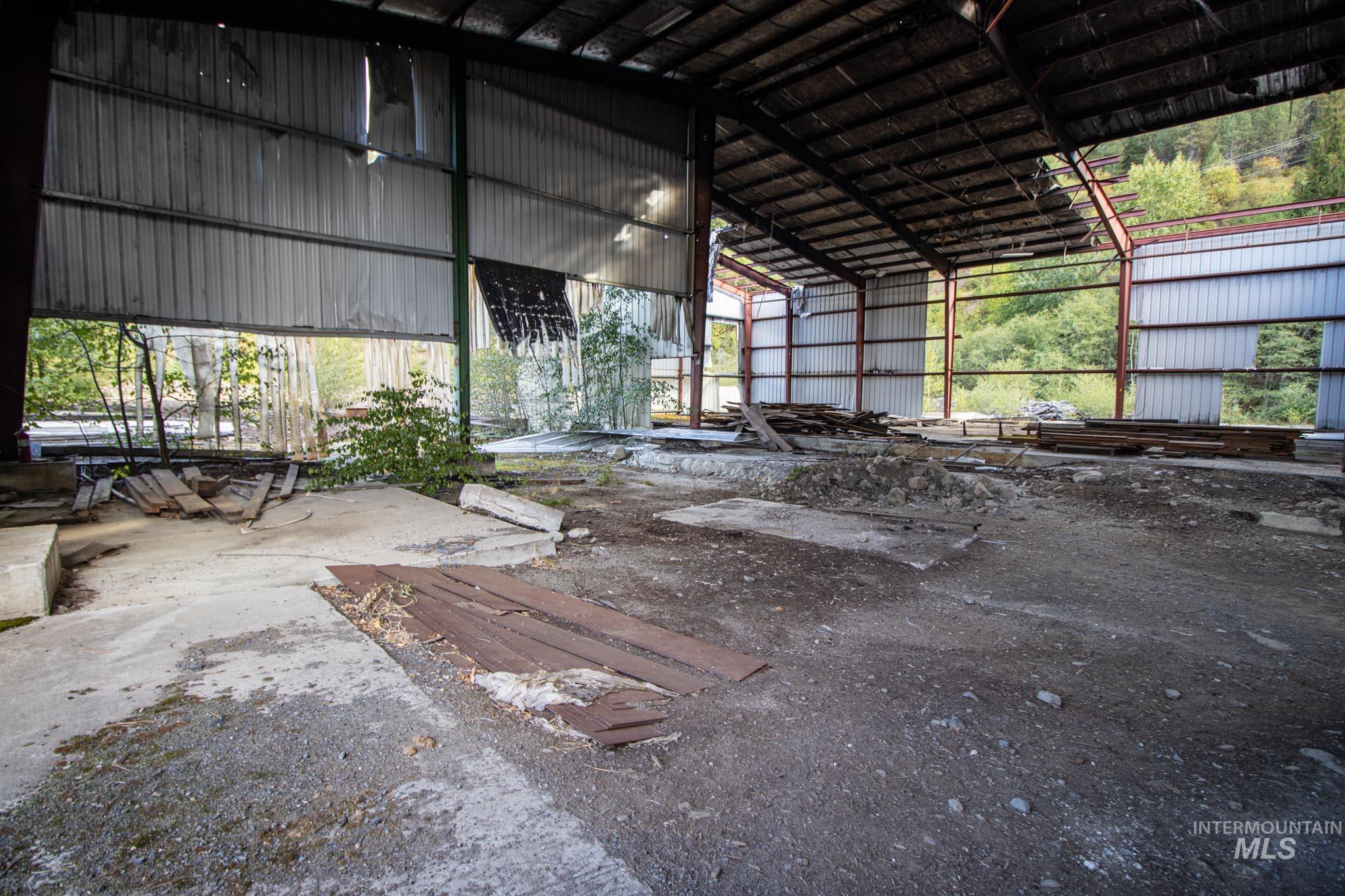 Miscellaneous room featuring metal wall and a towering ceiling