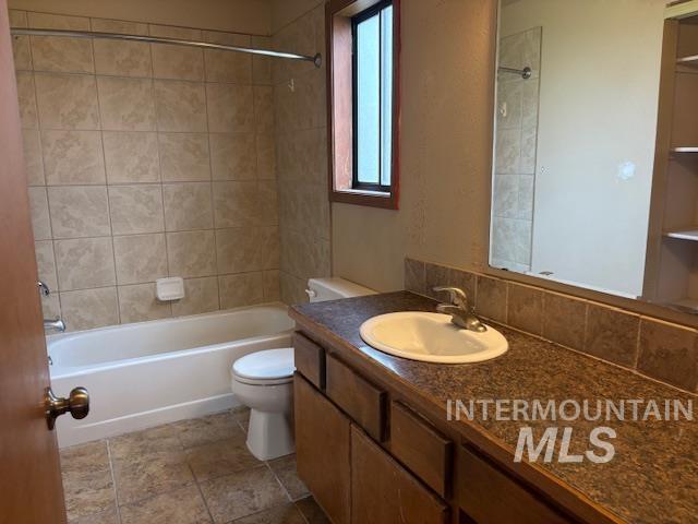 Bathroom with vanity and shower / washtub combination