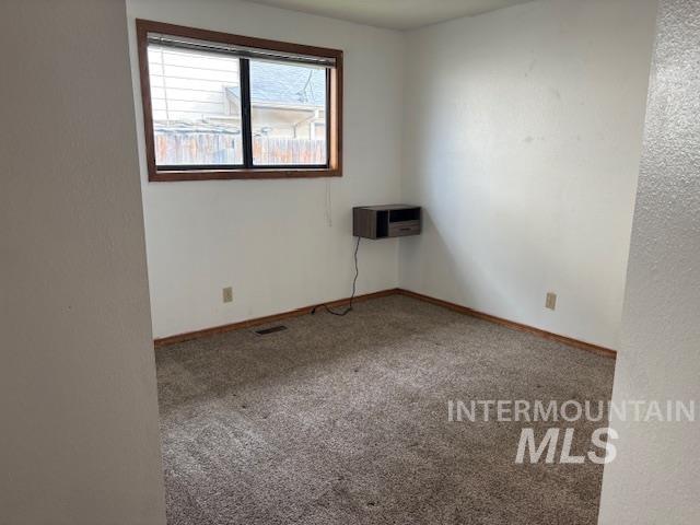 Spare room with carpet floors and baseboards