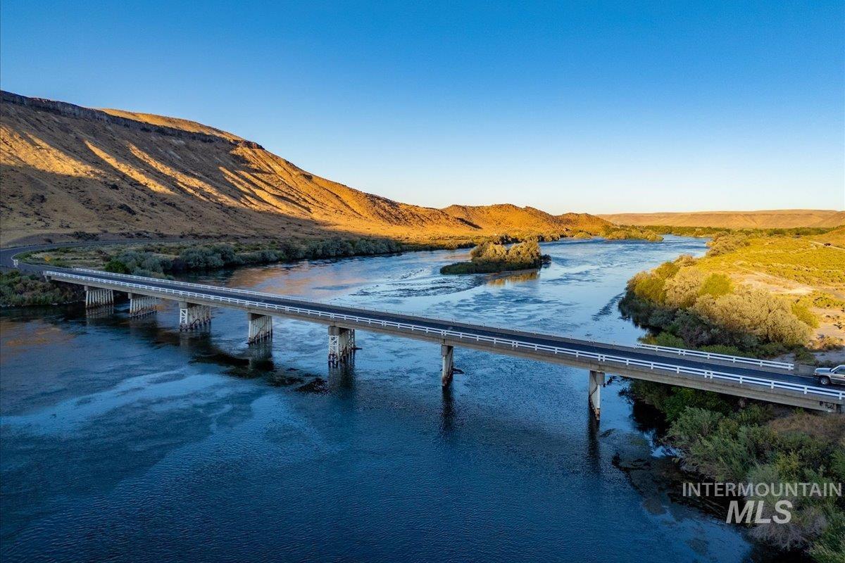 Water view with a notable bridge and mountains