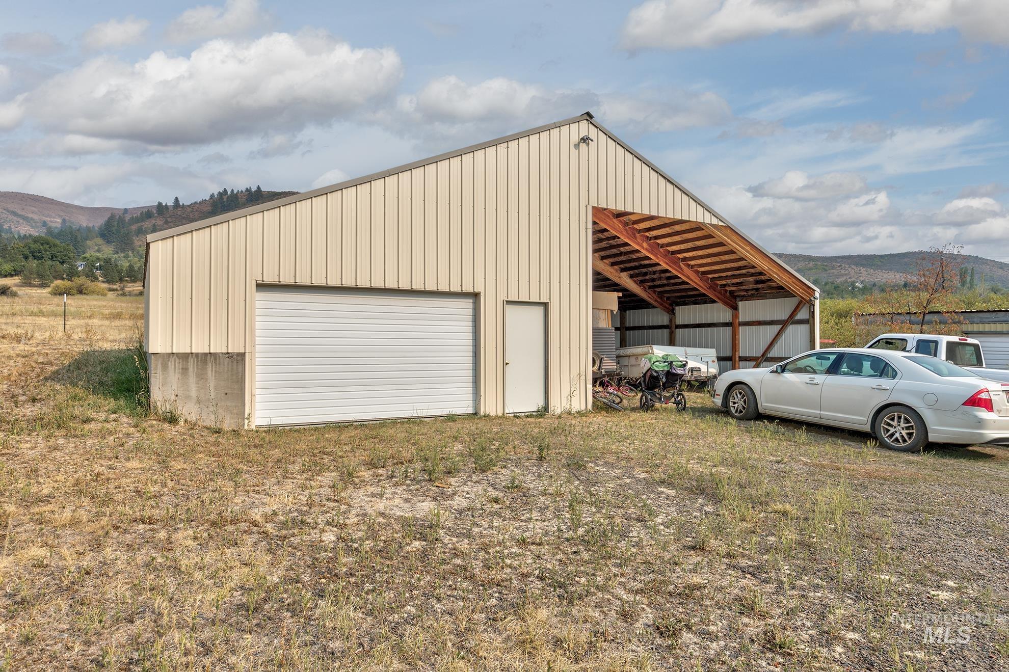 Detached garage with a mountain view and a carport