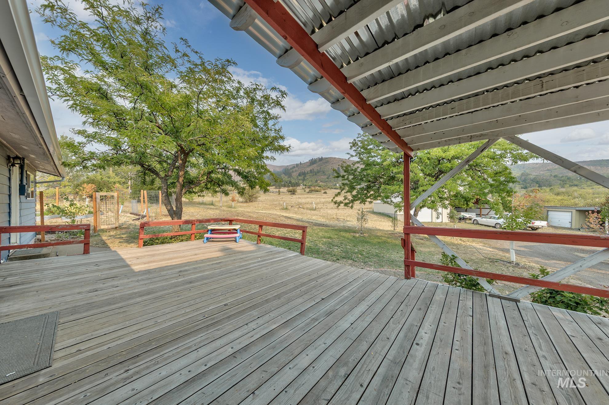 Deck featuring a mountain view and a yard