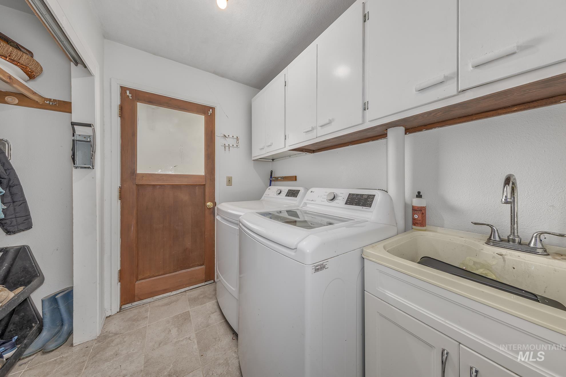 Washroom with cabinet space and washer and dryer