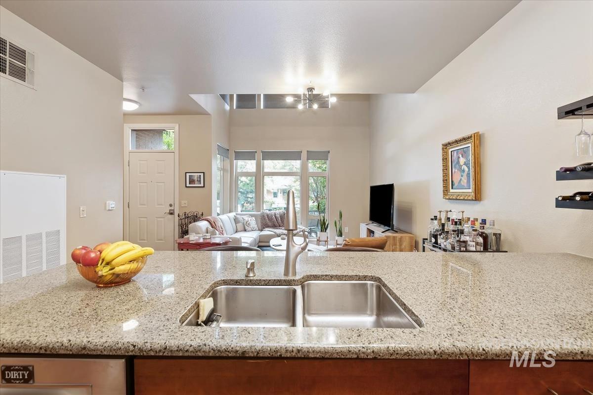 Kitchen with light stone counters and open floor plan