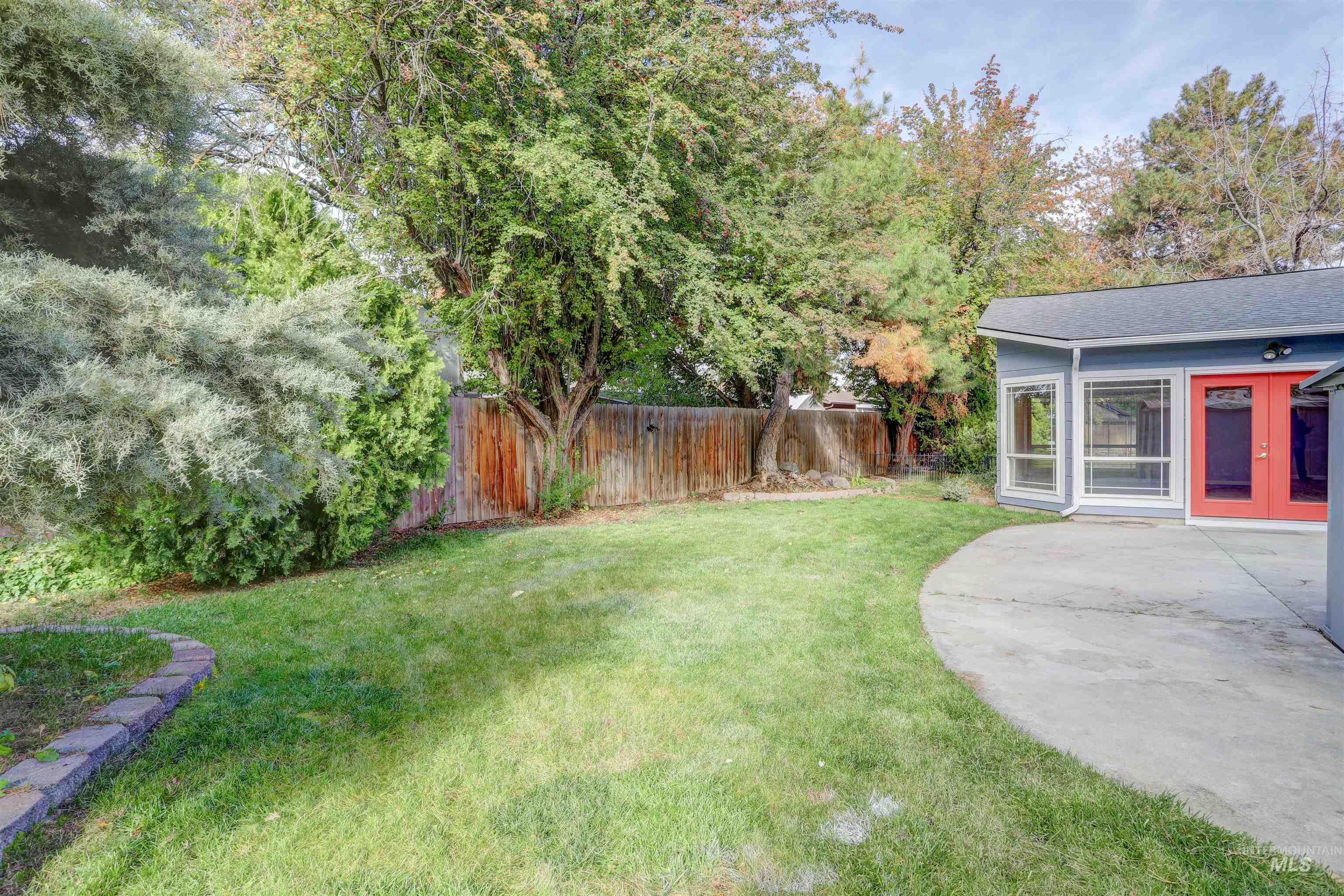 View of yard with french doors and a patio