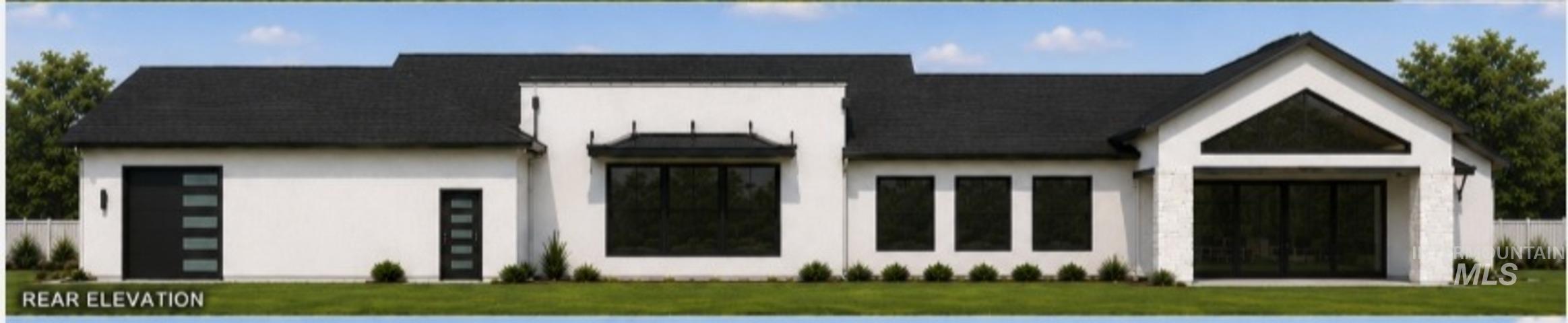 Rear elevation featuring a white stucco exterior and a dark shingle roof