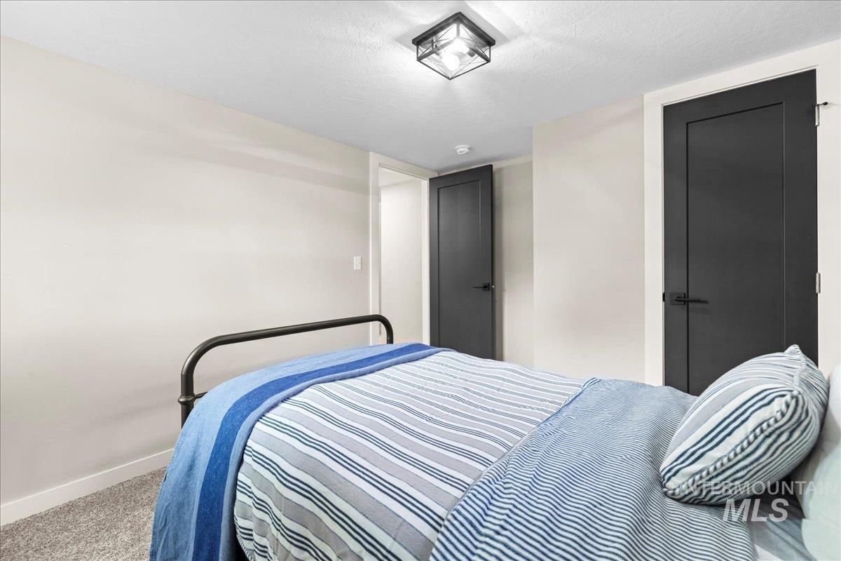 Bedroom with a textured ceiling and carpet floors