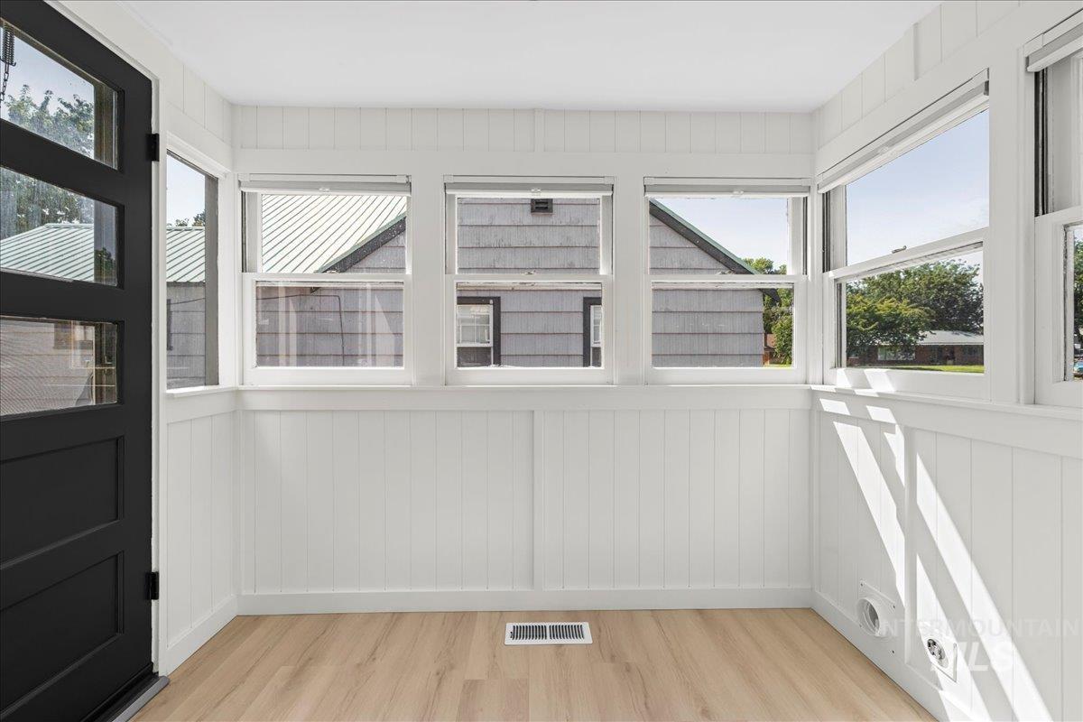 Entryway with wood finished floors and wooden walls