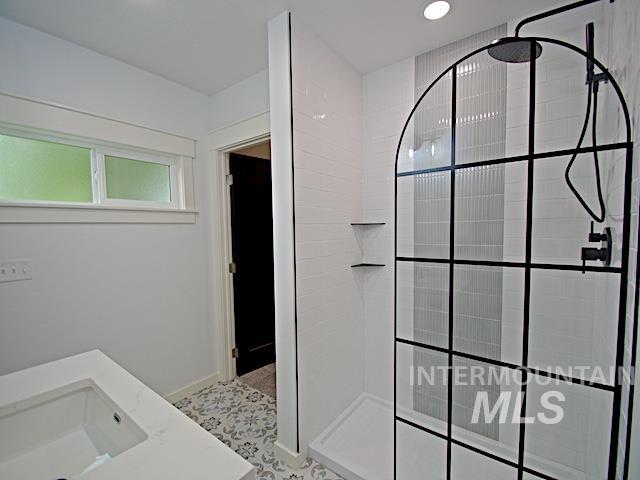 Full bath featuring walk in shower, vanity, and recessed lighting