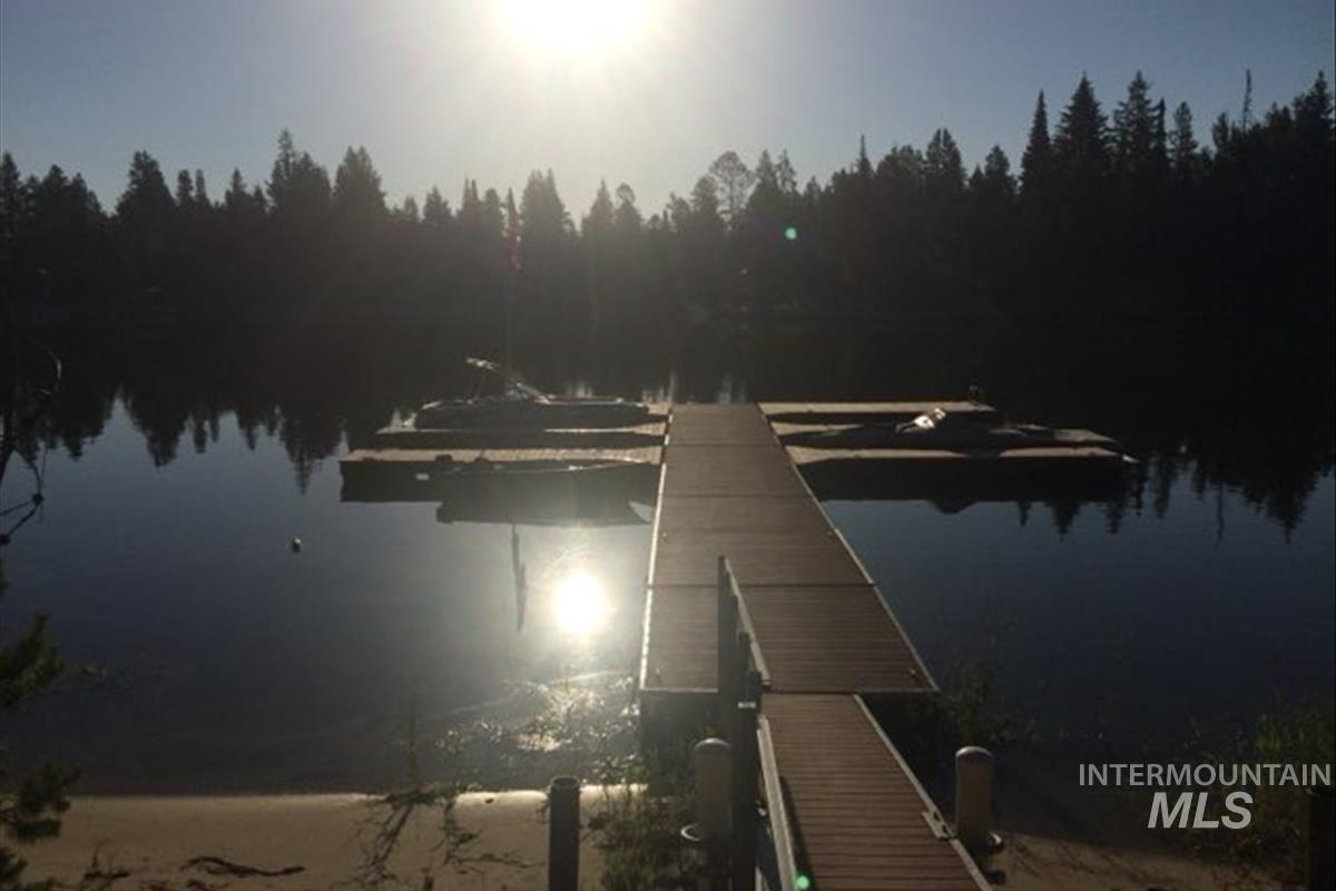 Dock area featuring a water view and a forest view