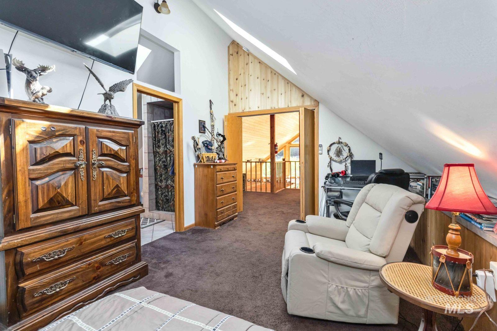 Carpeted bedroom featuring lofted ceiling and a skylight