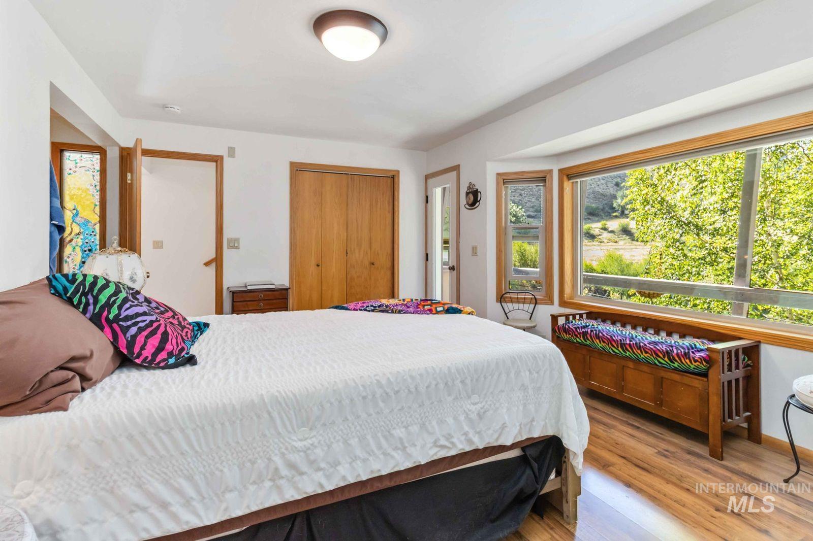 Bedroom featuring wood finished floors and a closet