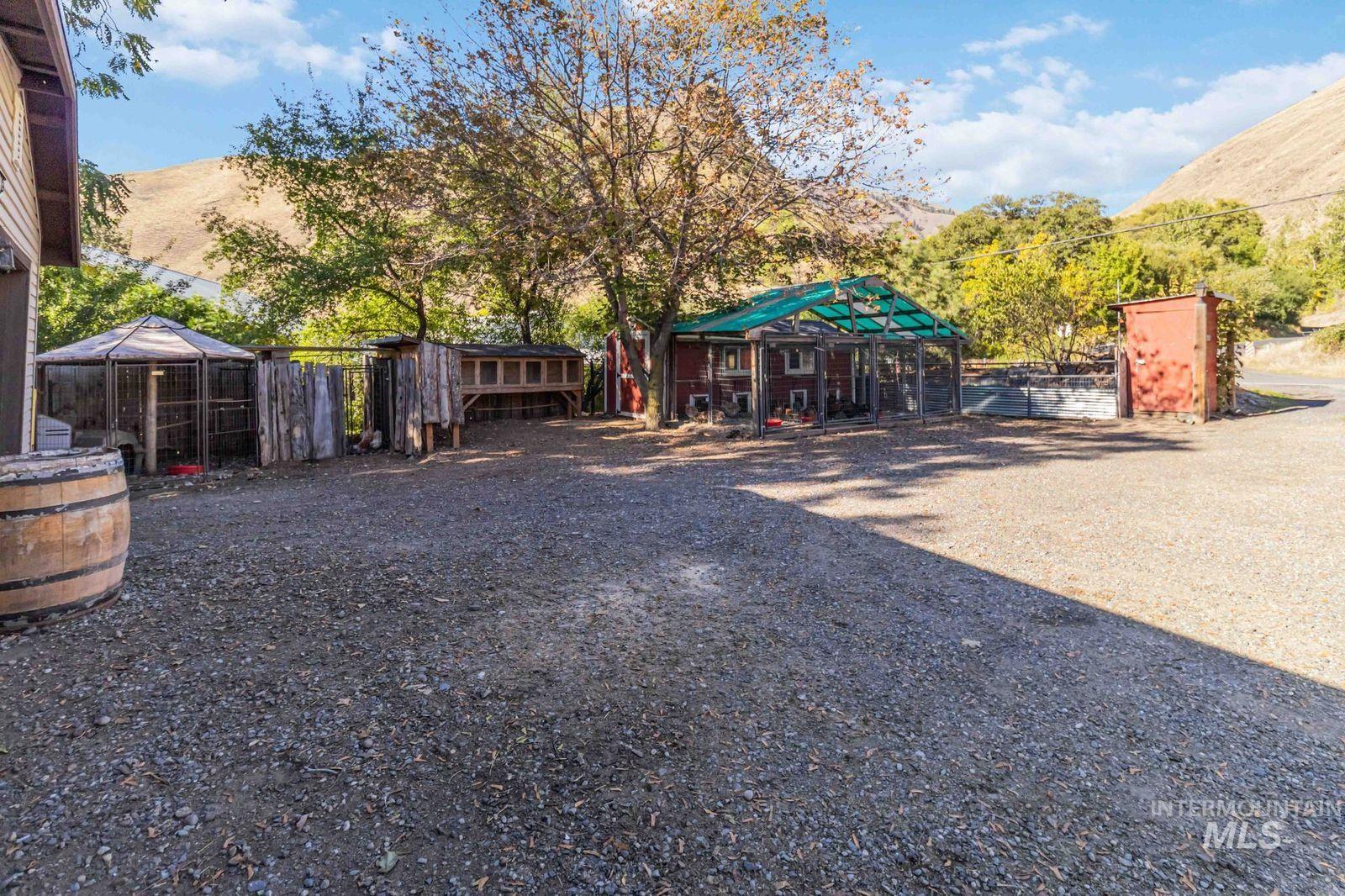 View of yard featuring a mountain view, an outdoor structure, and exterior structure