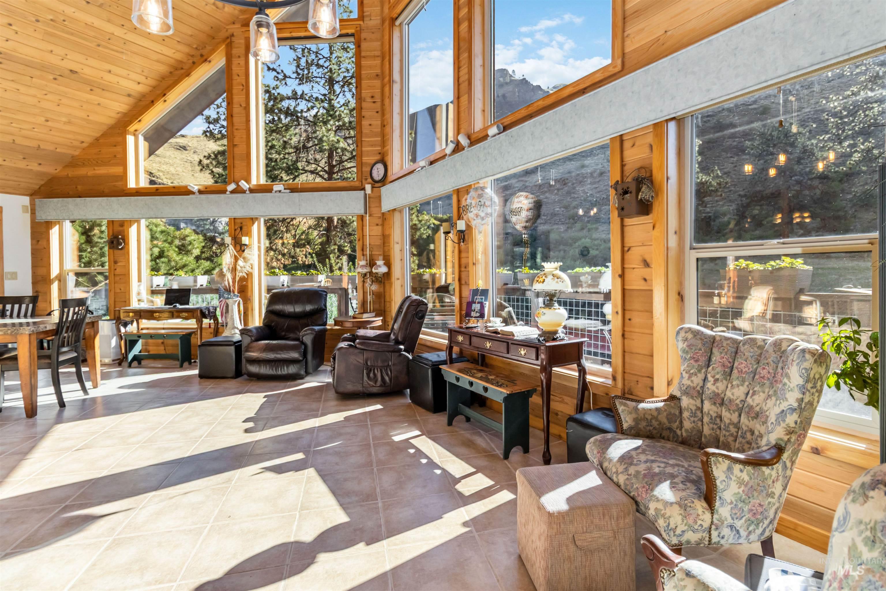 Sunroom featuring vaulted ceiling and healthy amount of natural light