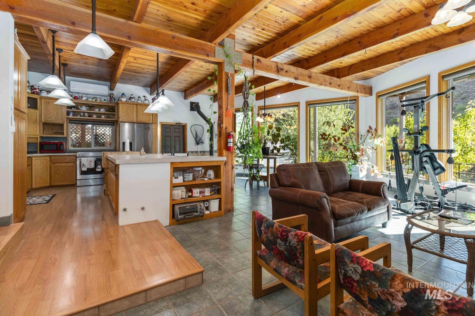 Living area with a wood ceiling with exposed beams