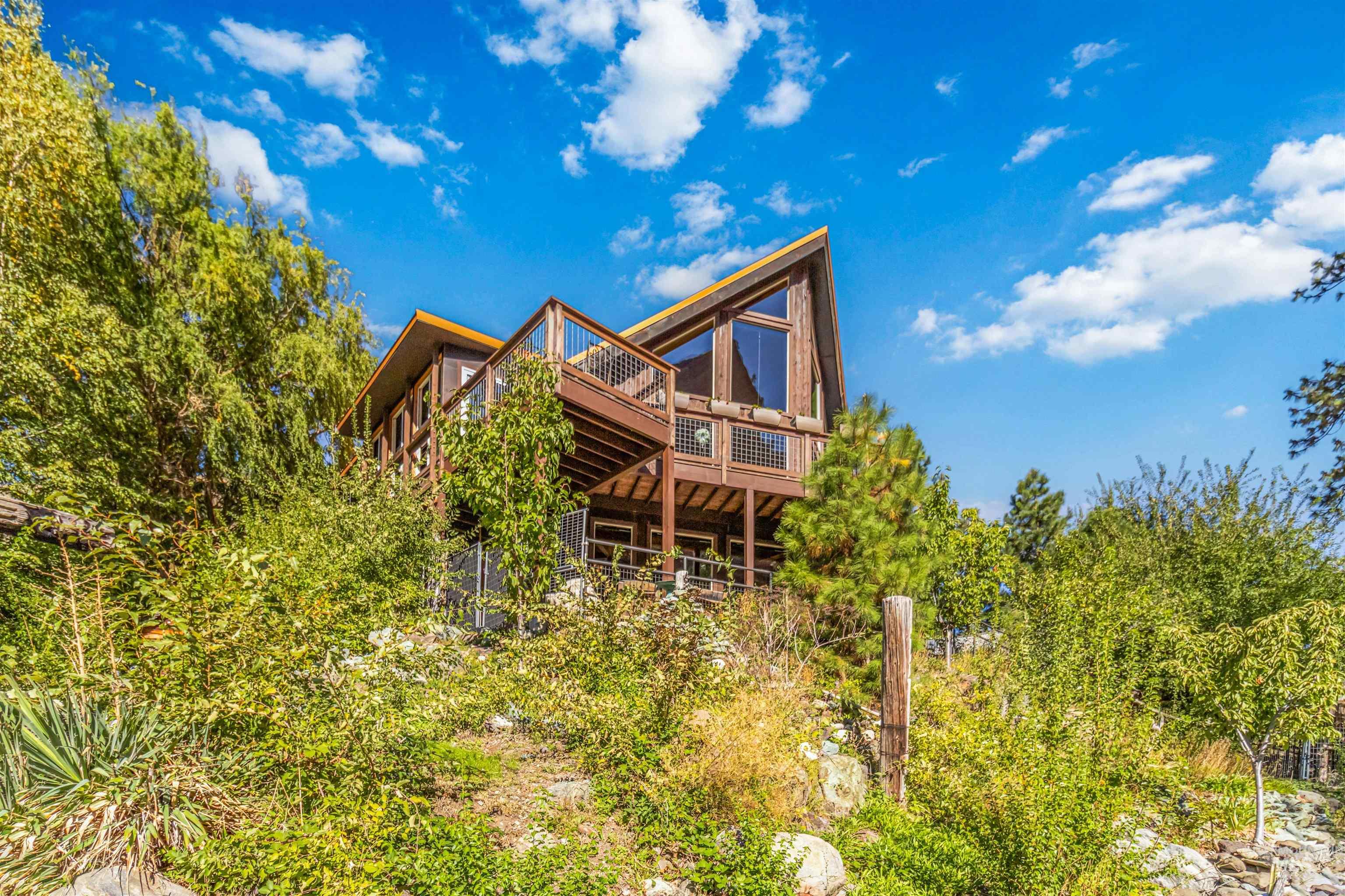 Rear view of house featuring a wooden deck