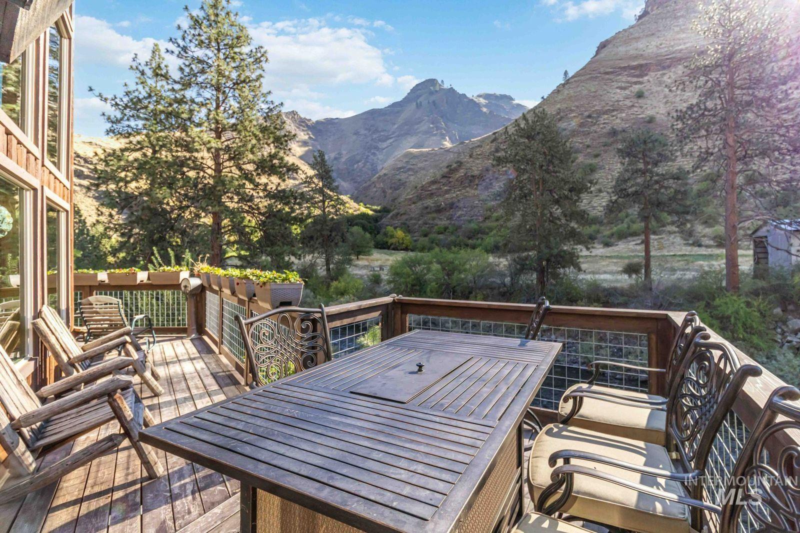 Wooden terrace with outdoor dining area and a mountain view