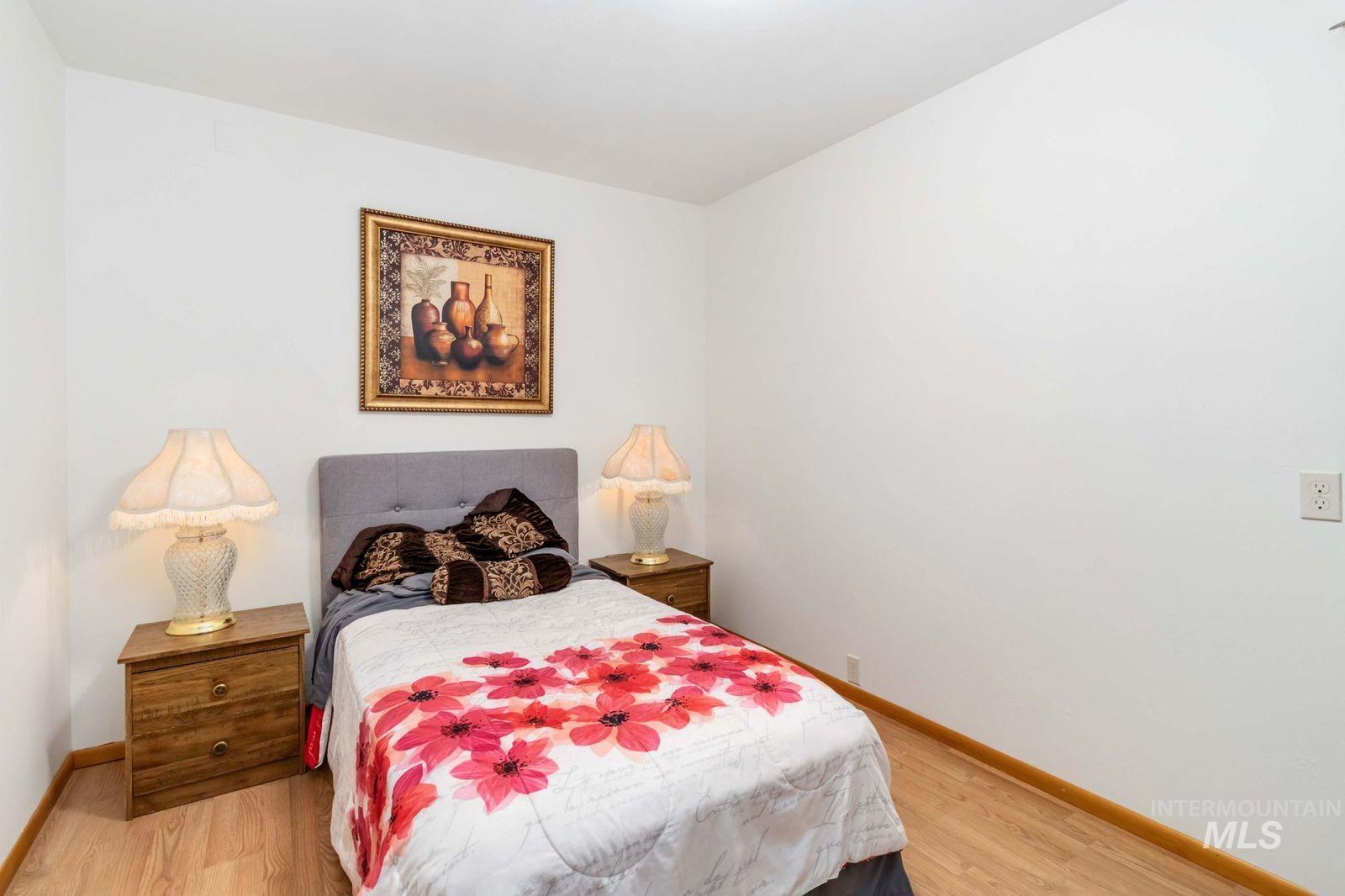 Bedroom with light wood-type flooring and baseboards