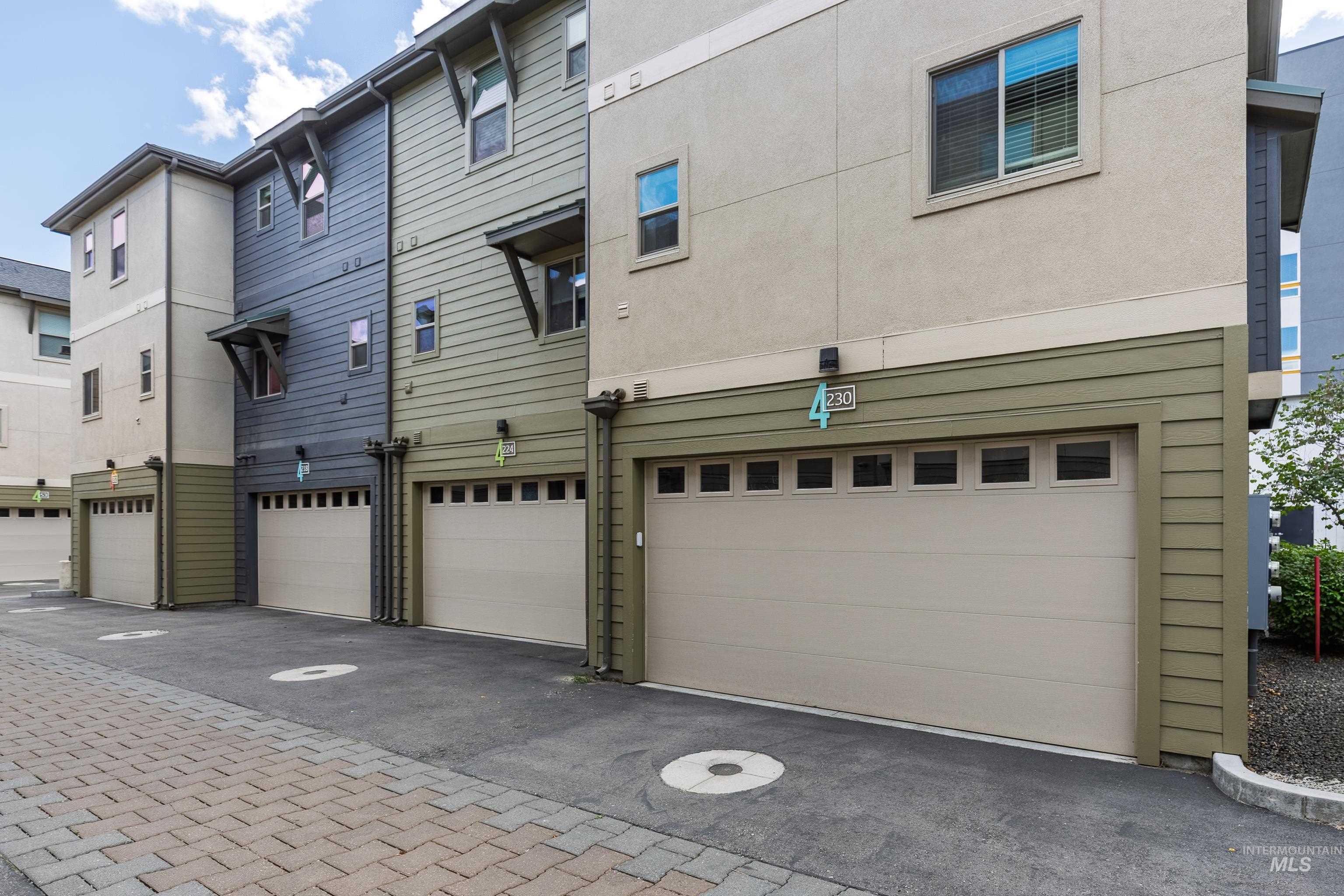 Back of property with stucco siding and a garage