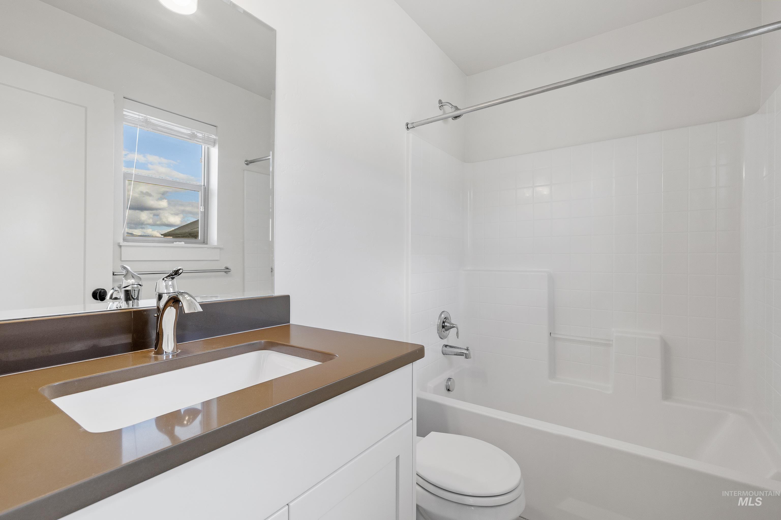 Bathroom featuring tub / shower combination and vanity