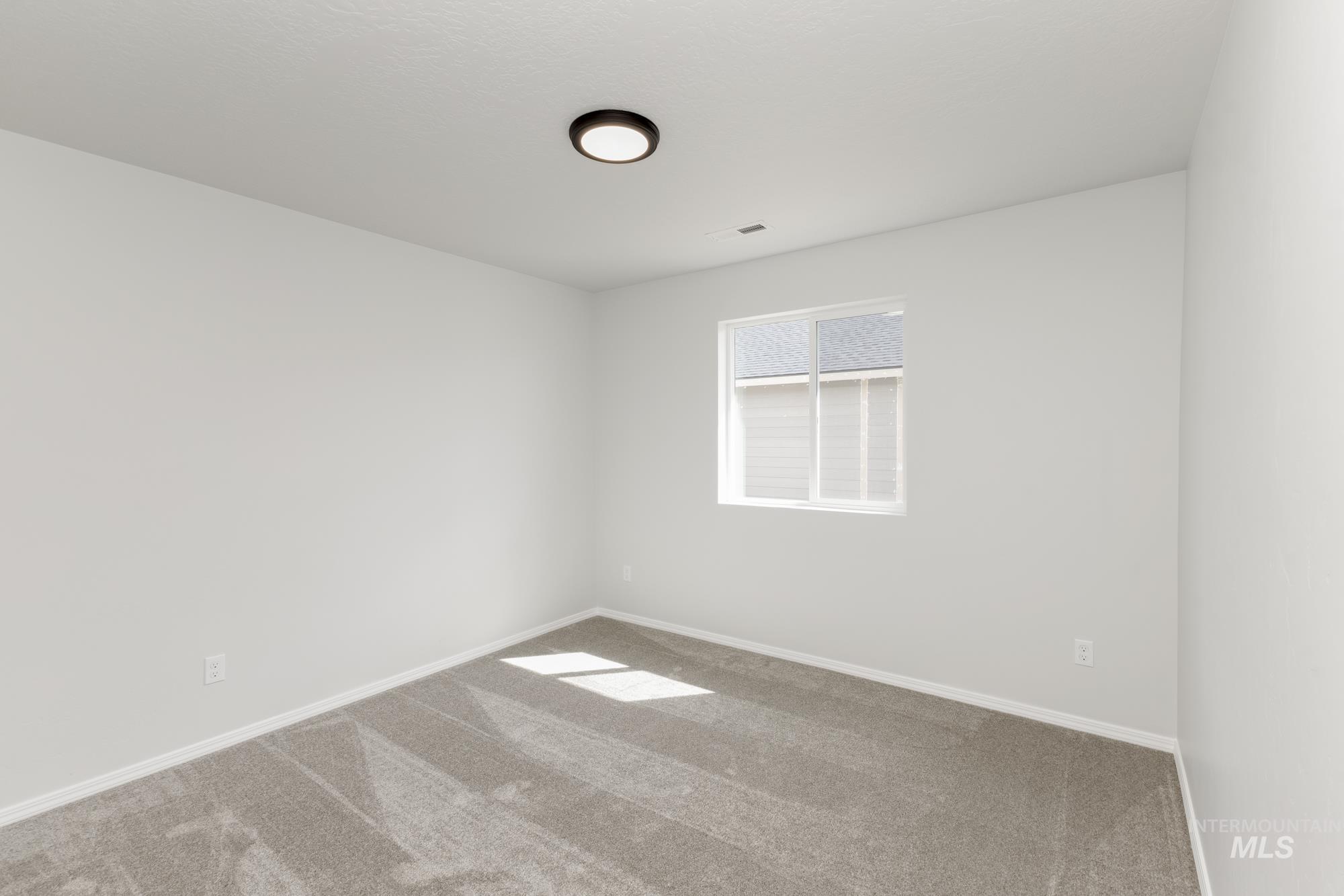 Unfurnished room with carpet flooring and baseboards
