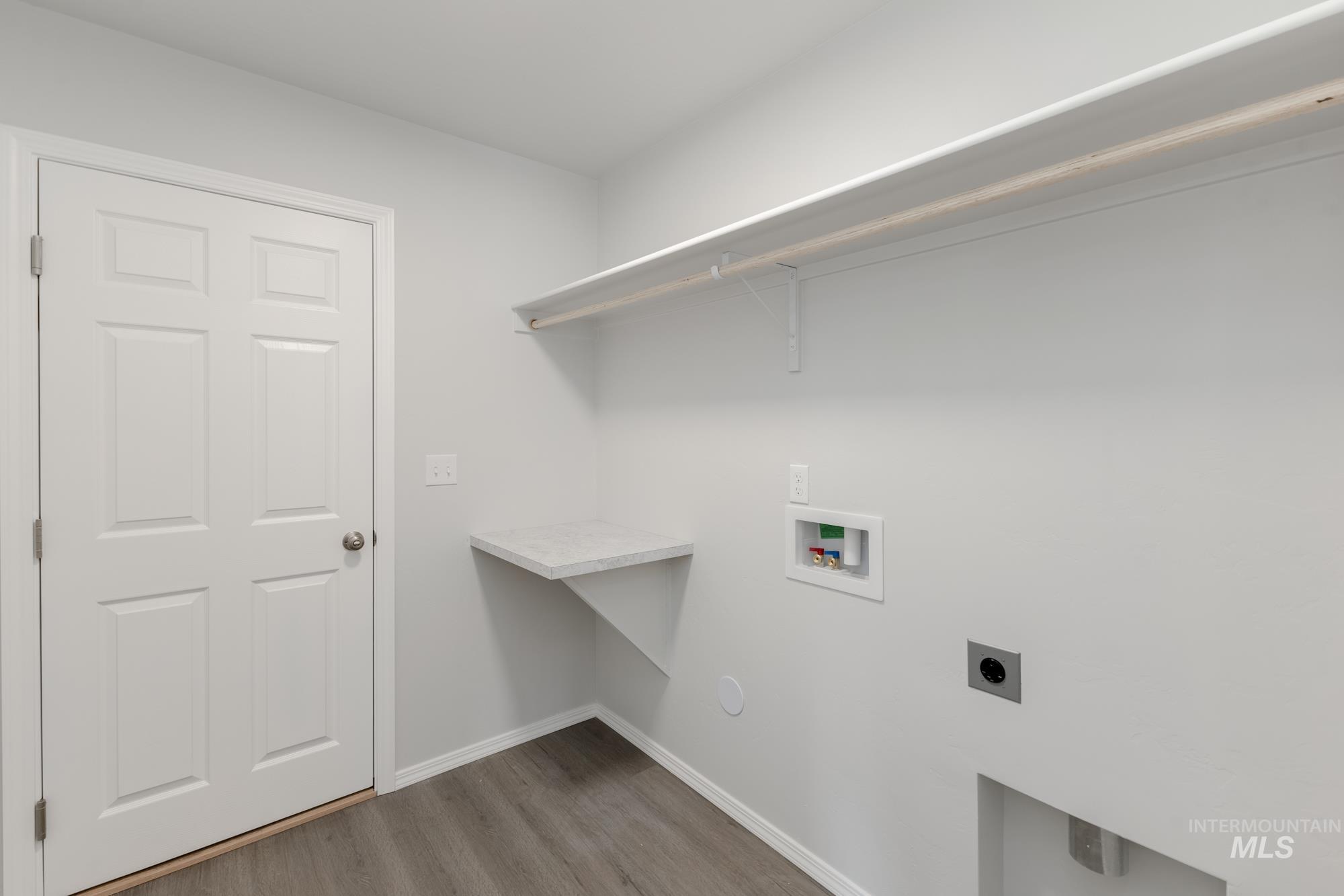 Washroom with washer hookup, light wood-type flooring, and electric dryer hookup