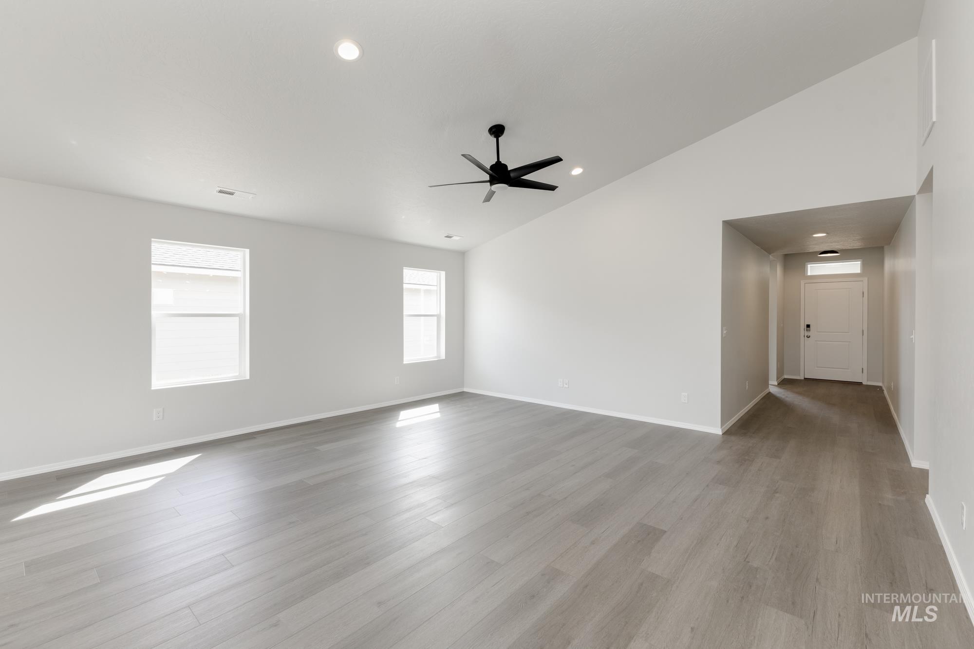 Spare room with recessed lighting, light wood-style flooring, vaulted ceiling, and ceiling fan