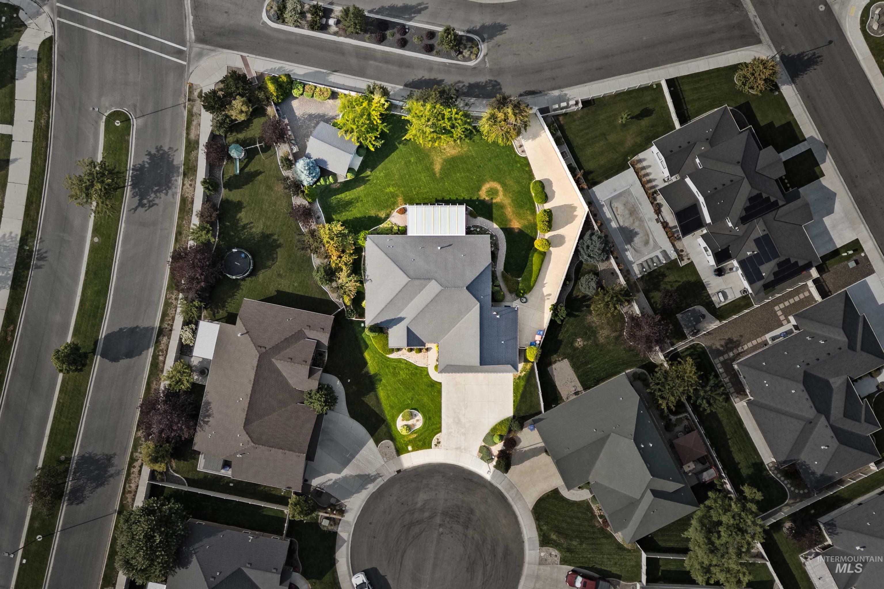 Aerial view of property and surrounding area featuring nearby suburban area