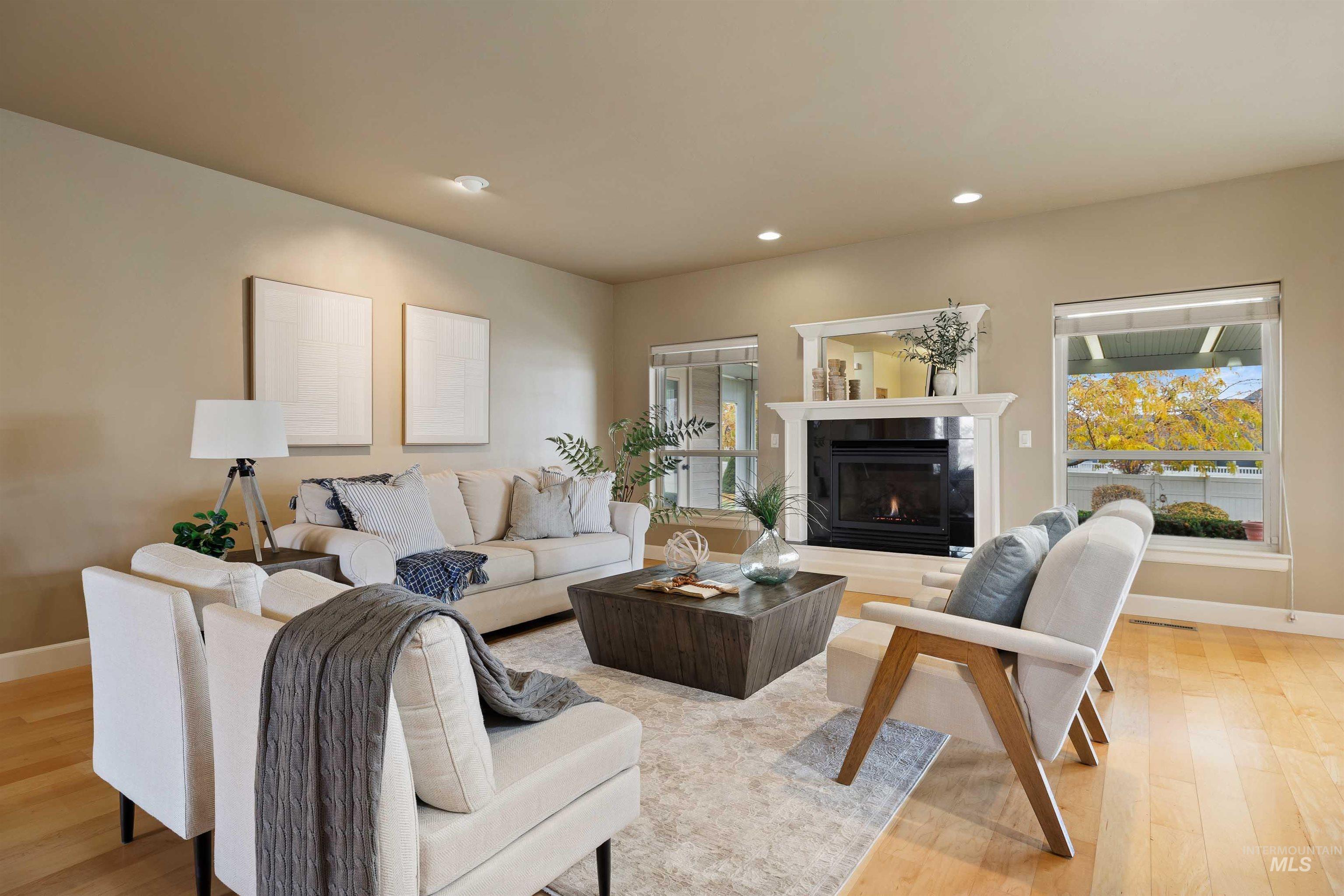 Living area featuring light wood-type flooring, recessed lighting, and a tile fireplace