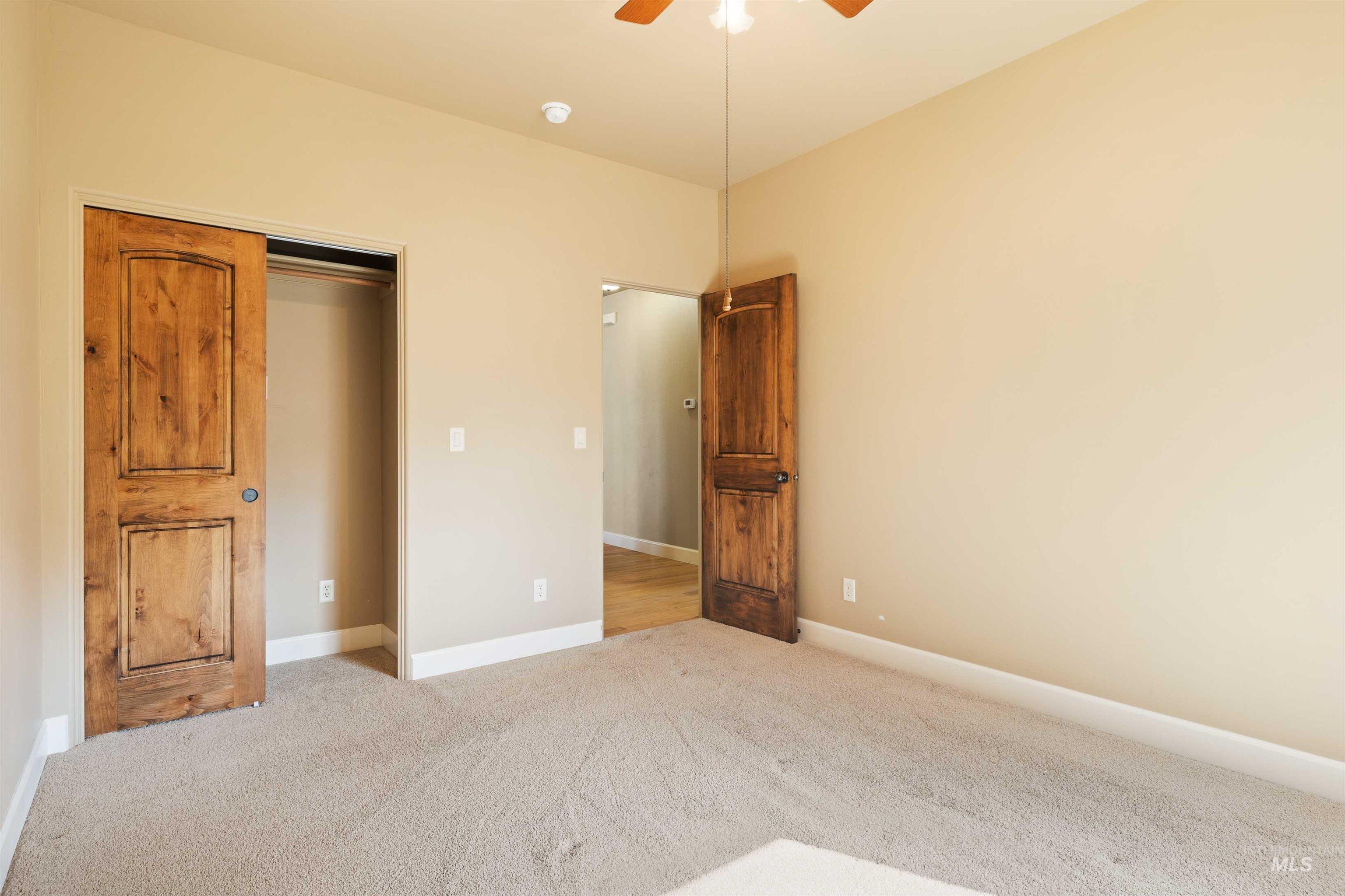 Unfurnished bedroom with carpet flooring, ceiling fan, and a closet